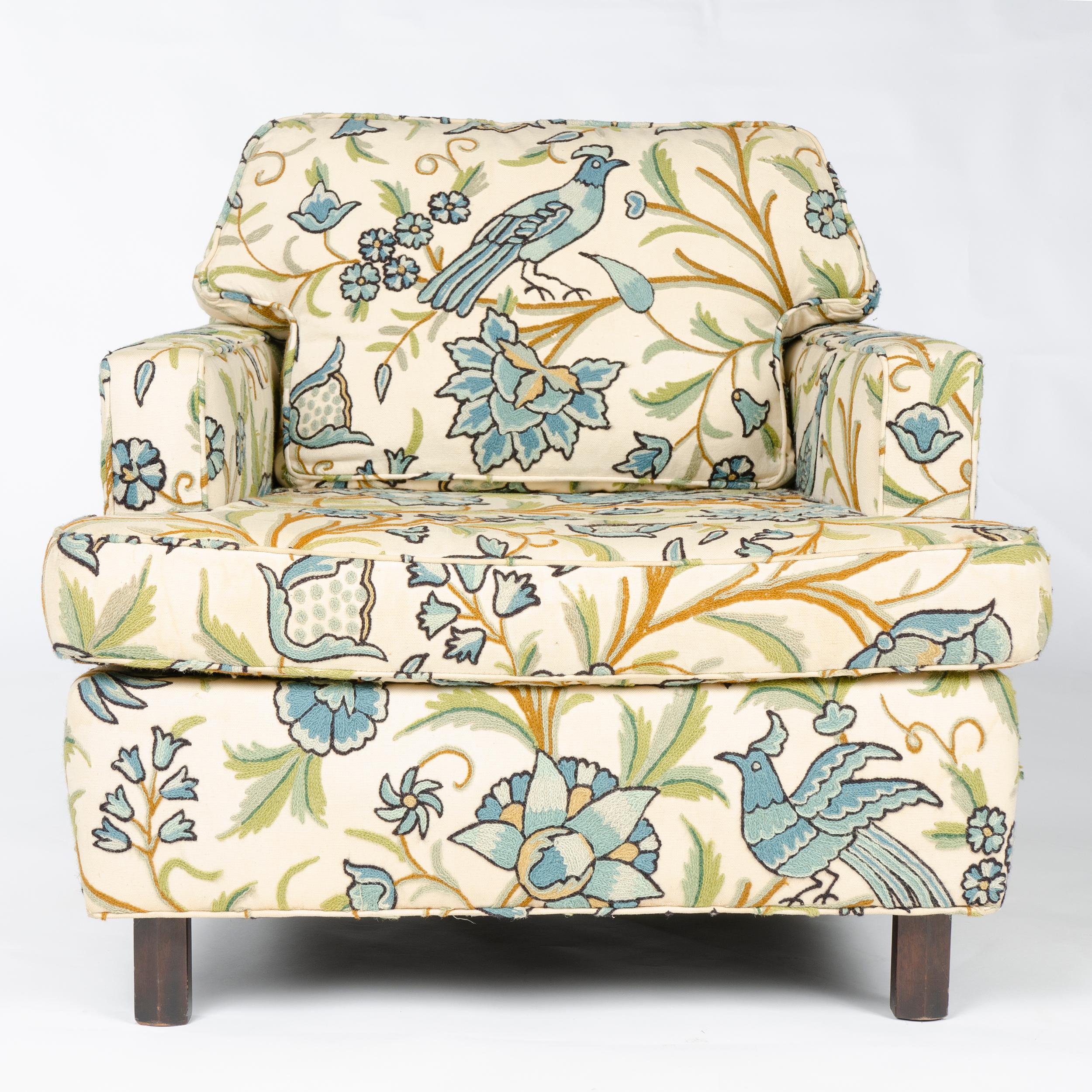 An upholstered lounge chair in vintage flora and fauna print having two swivel casters, designed in 1958 as an addition to the Conversations Group introduced in 1955.