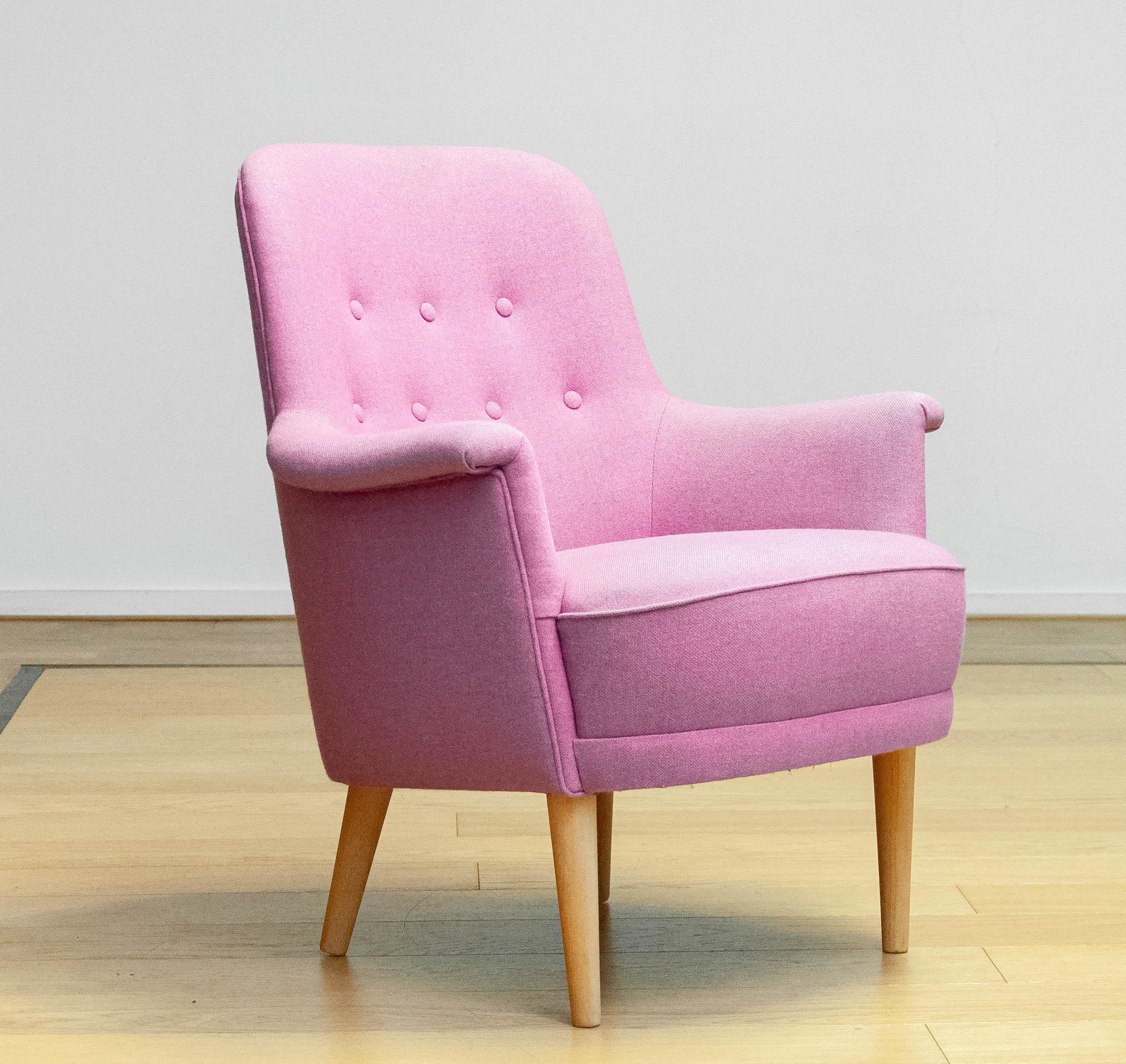 Beautiful Swedish armchair designed by Carl Malmsten for O.H. Sjogren. The chair has been reupholstered with this eye-catching pastel lilac wool and restored in a later period and therefor sits and supports good. 
The chair is marked underneath and