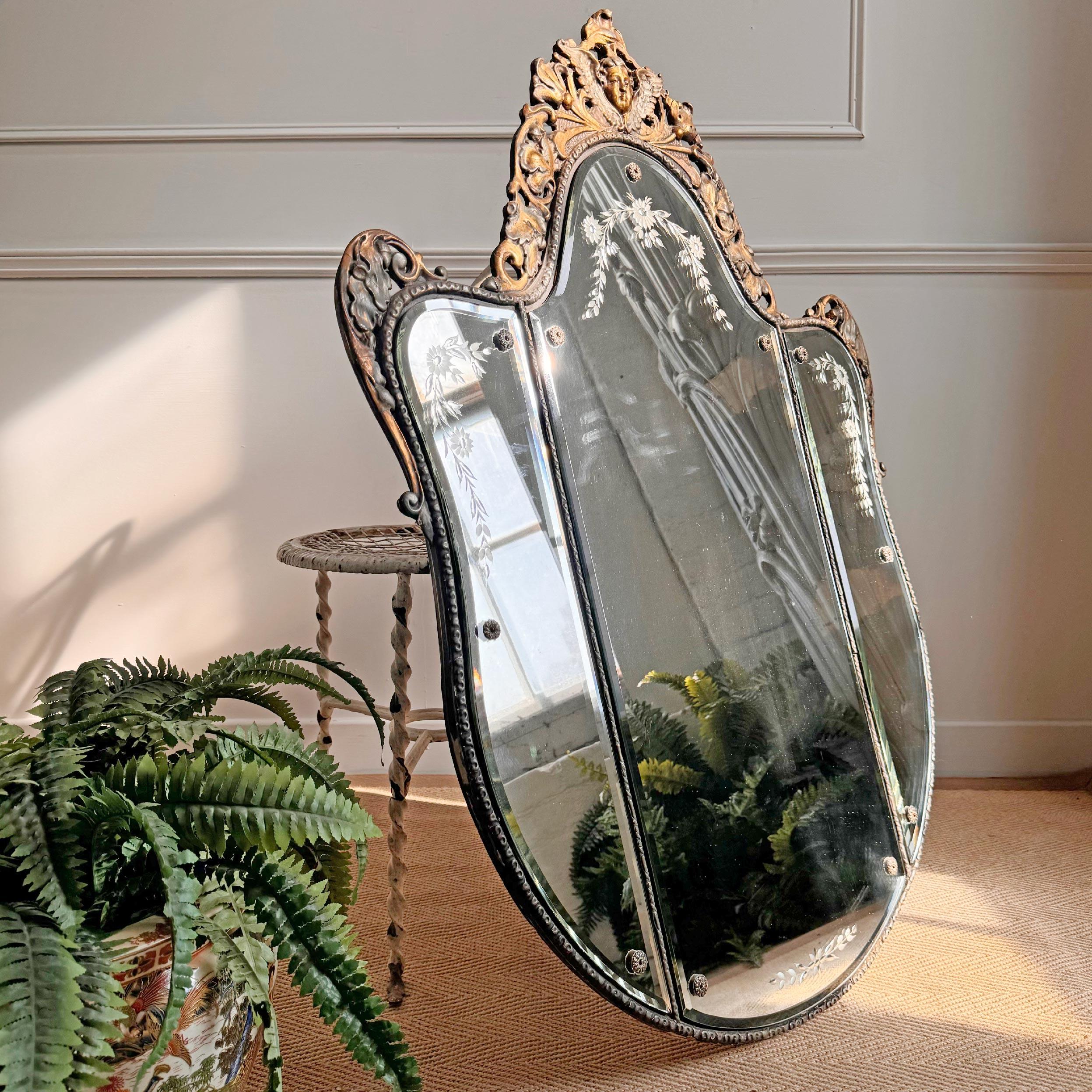 Stunning large Venetian mirror, of shield form with three separate bevelled and etched mirror plates, surrounded by gilt gesso decoration and a putto crest, dating to the early 1950’s.



Height 108 cm x Width 81 cm x Depth 4 cm

Mirror Plate 91 cm