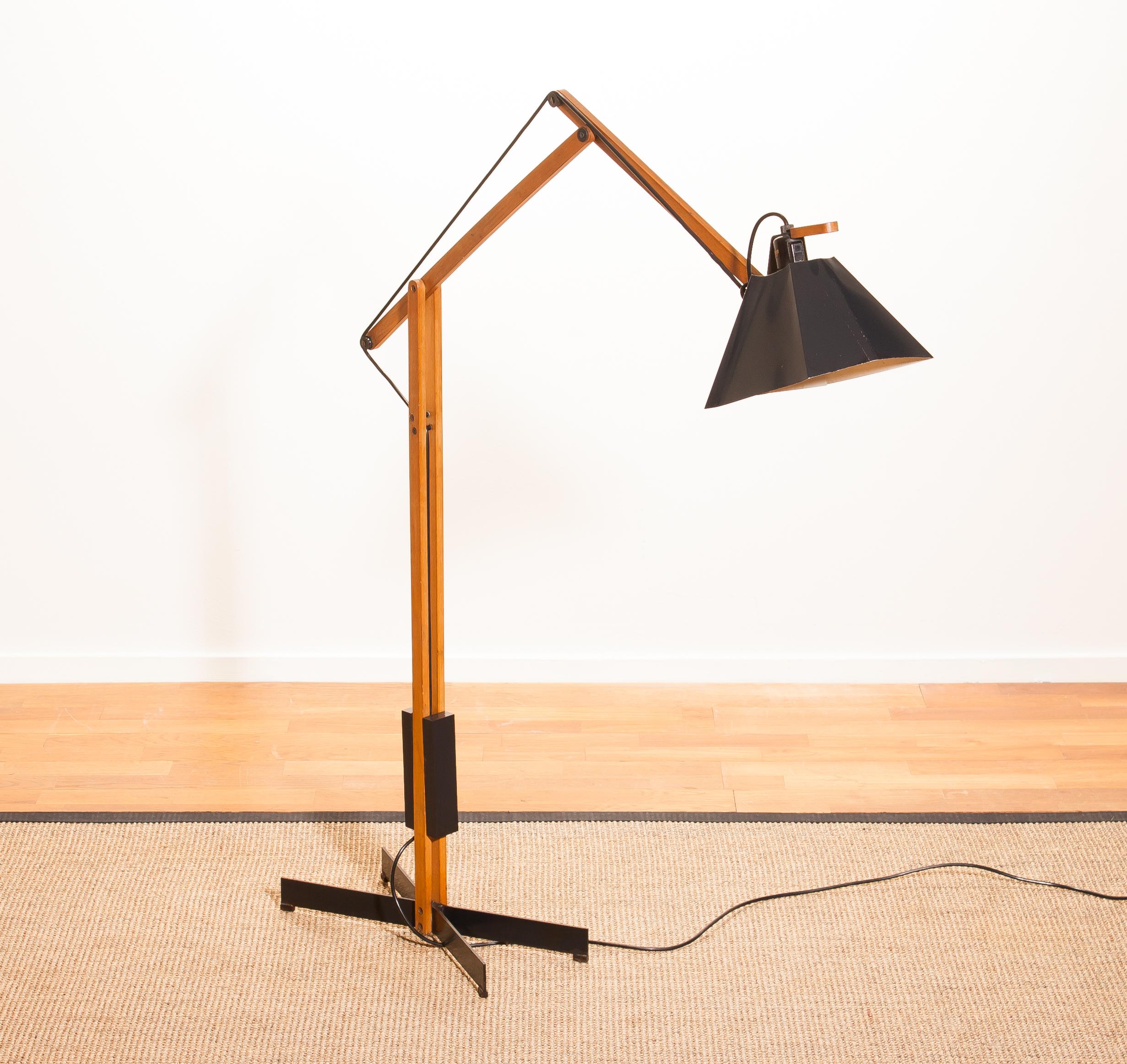 Magnificent rare floor lamp by Luxus, Sweden.
This lamp is adjustable by a counterbalance.
The stand is made of teak with a black lacquered shade.
It is labelled by Luxus and in a beautiful condition,
circa 1950s.
Dimensions: H 125 cm, D 90 cm,