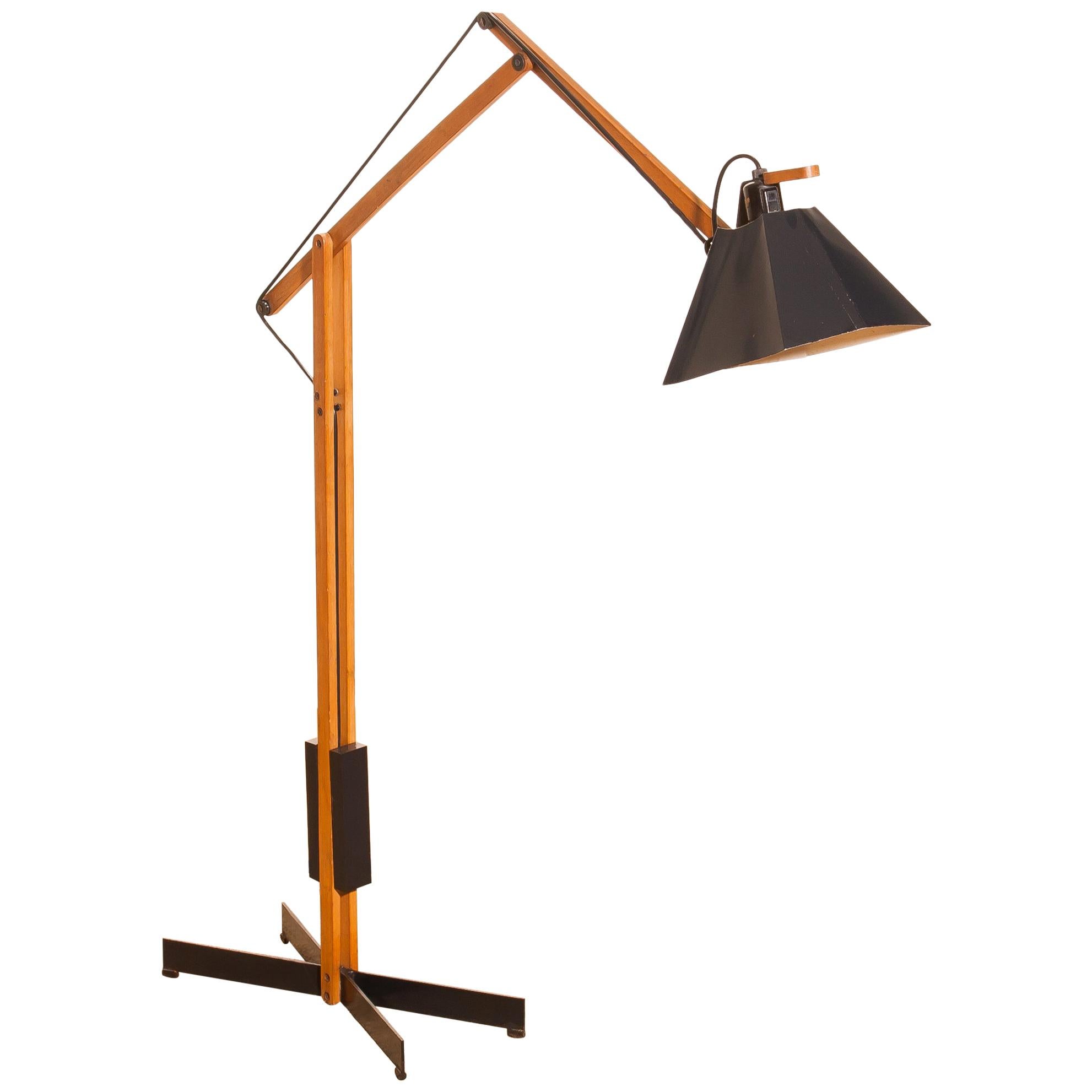 Magnificent rare floor lamp by Luxus, Sweden.
This lamp is adjustable by a counterbalance.
The Stand is made of teak with a black lacquered shade.
It is labelled by Luxus and in a beautiful condition,
circa 1950s.
Dimensions: H 125 cm, D 90 cm,