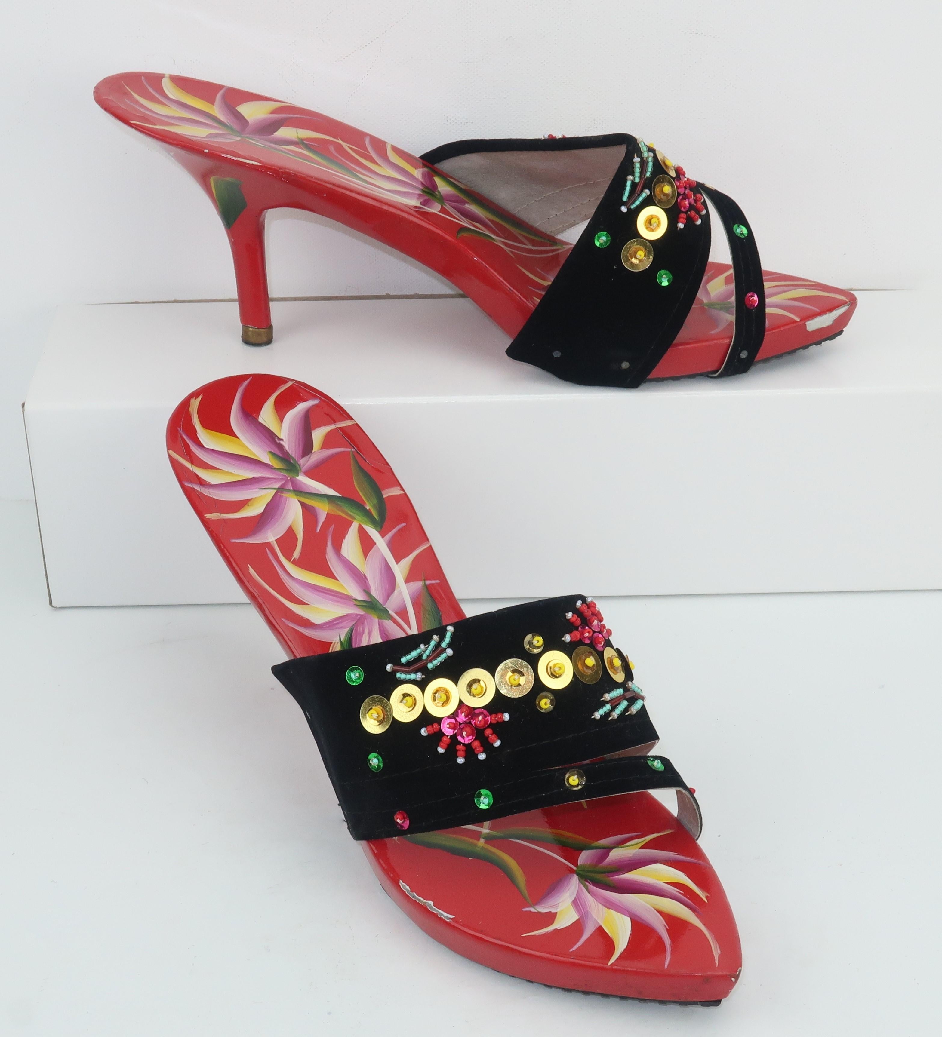 A classic 1950's heeled mule shoe with the exotic touch of a wooden hand painted base decorated in shades of bright red, orchid purple, yellow, white and green.  The vamp is a black felted fabric embellished with sequins and beading in shades of