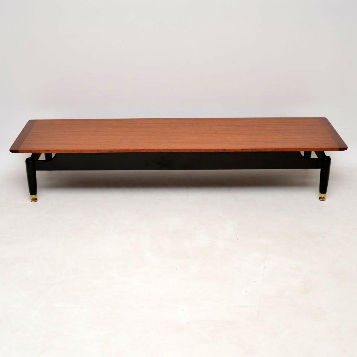 A stylish and extremely well made vintage coffee table by G- Plan, this dates from the 1950-60’s. The top is beautiful afromosia wood, the base is ebonised wood and sits on brass adjustable feet. It’s a great size, very low and long, this could be