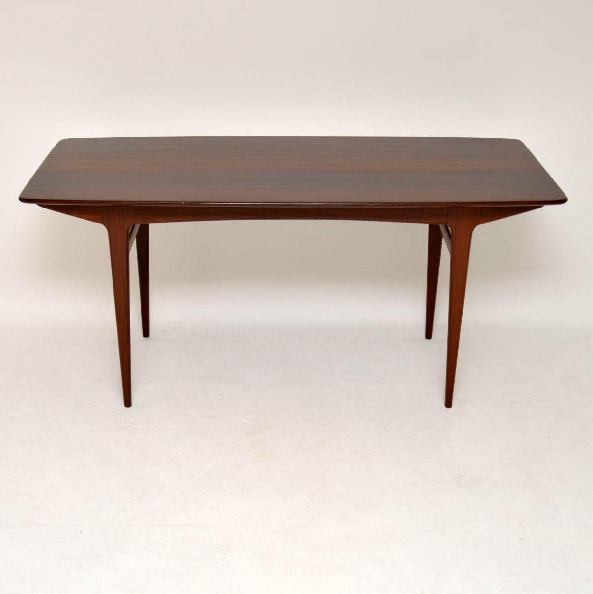 A stylish and extremely well made vintage dining table in solid afromosia wood, this was made by Younger furniture in the 1950s-1960s. The quality is amazing, this is a useful size, long and slim, to comfortably seat six. We have had this stripped