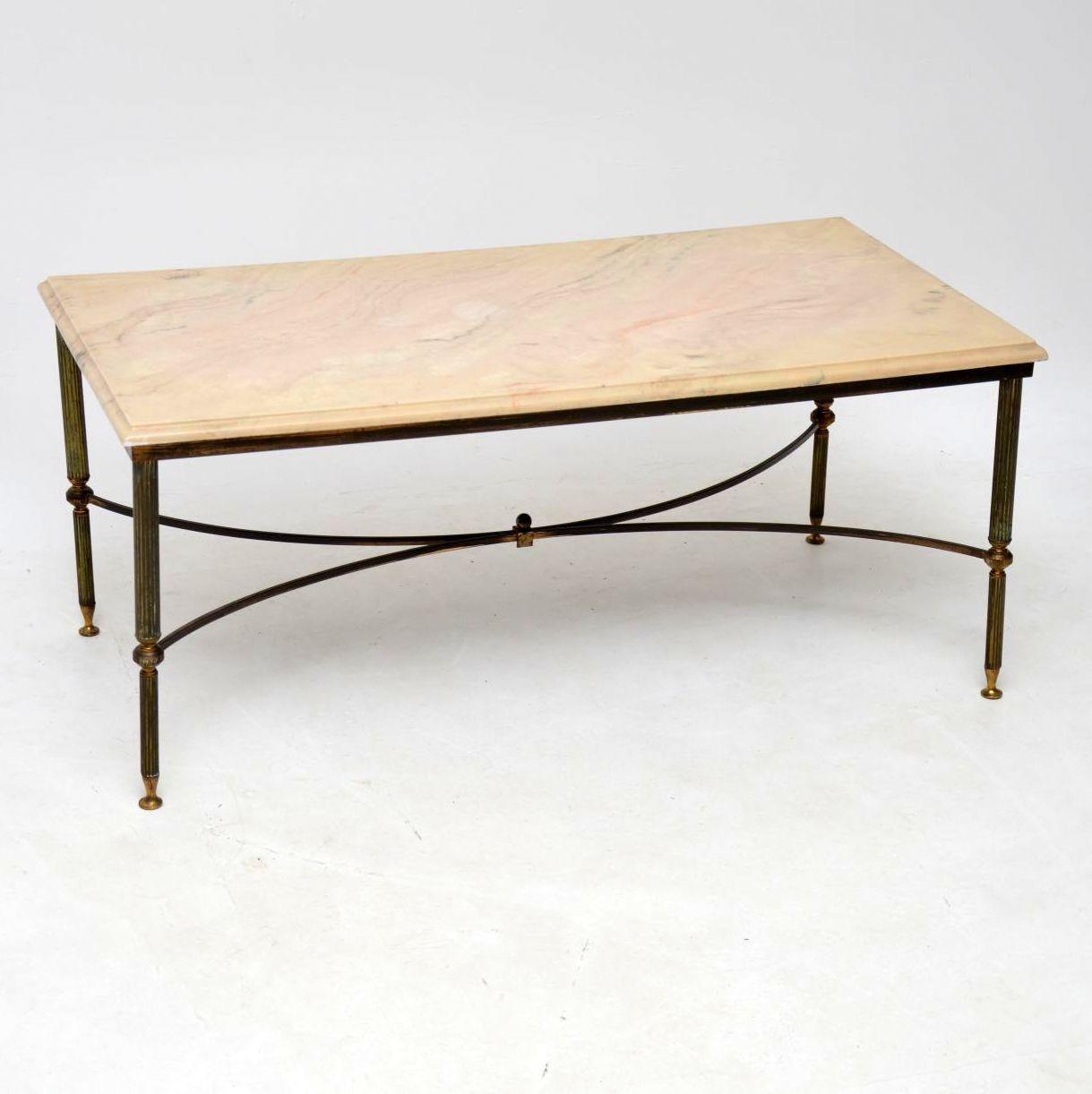A lovely vintage coffee table with a brass frame and marble top, this was made in France, it dates from around the 1950s-1960s. The brass has some fairly heavy patina which gives it great character, this is just surface wear and there is no real
