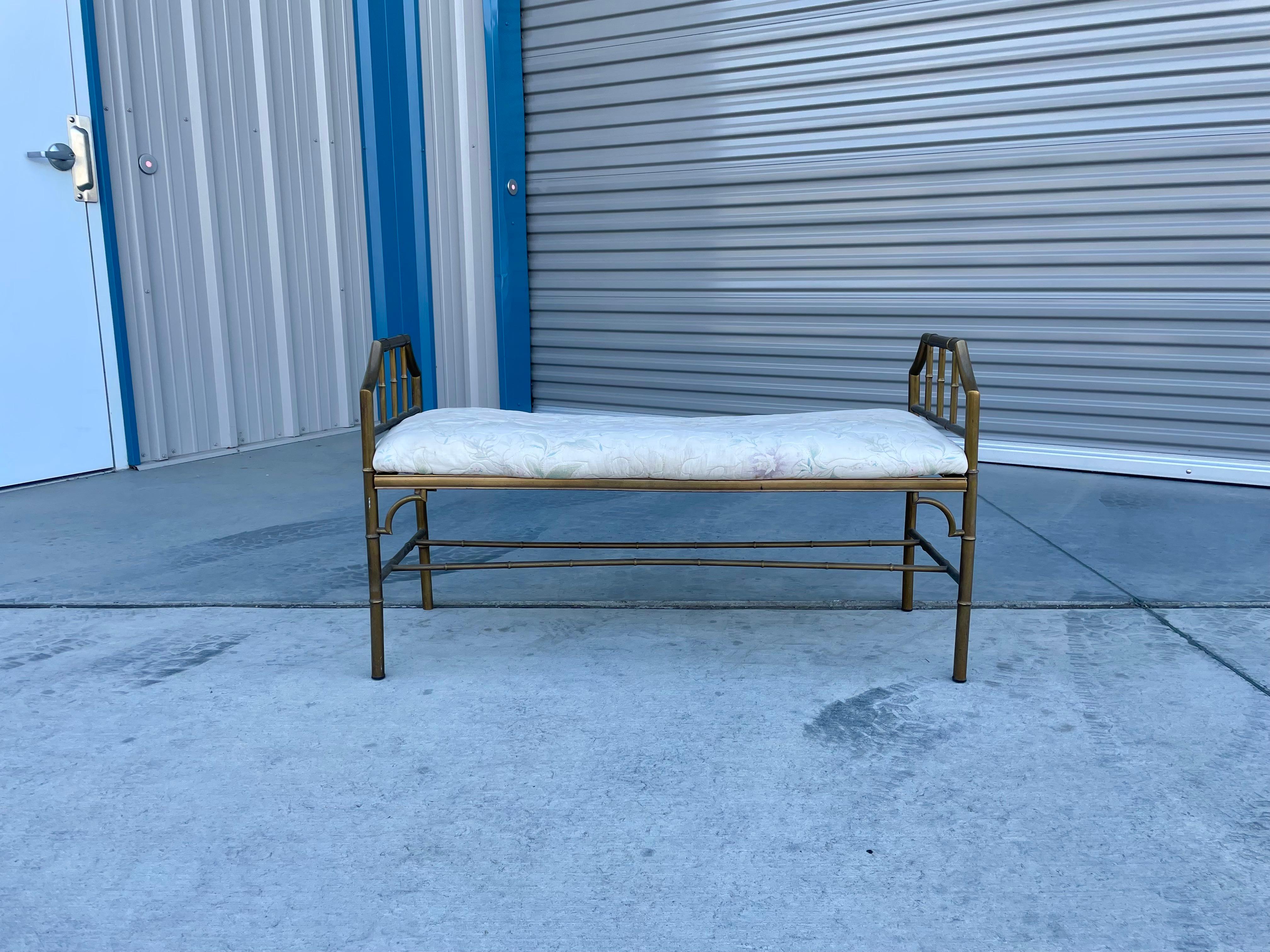 Vintage brass bamboo style bench designed and manufactured in the United States in the 1950s.This beautiful bench showcases a unique design with its bamboo-style frame that gives it a vintage and forest-like shape. Moreover, the bench boasts a