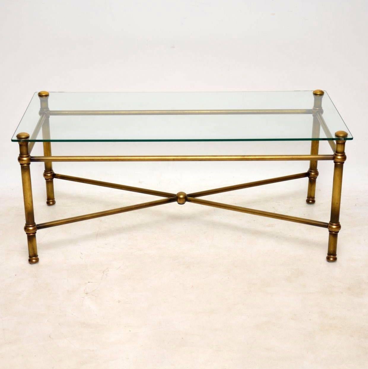 A very stylish and top quality vintage coffee table in brass with a fixed glass top, this dates from the 1950-60s, it was most probably made in France. The condition is excellent for its age, the brass has a beautiful patina, the clear glass top is