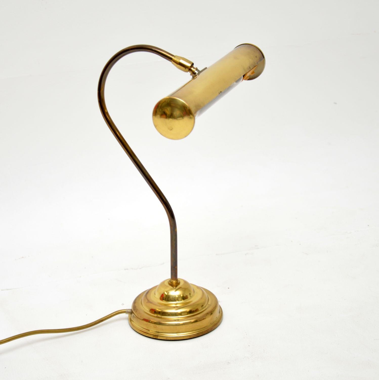 A fabulous vintage brass desk lamp, this was made in England, and dates from the 1950-60’s.

It is very well made with a lovely design. The elongated shade can tilt and swivel to adjust the angle of light.

The quality is excellent and this is