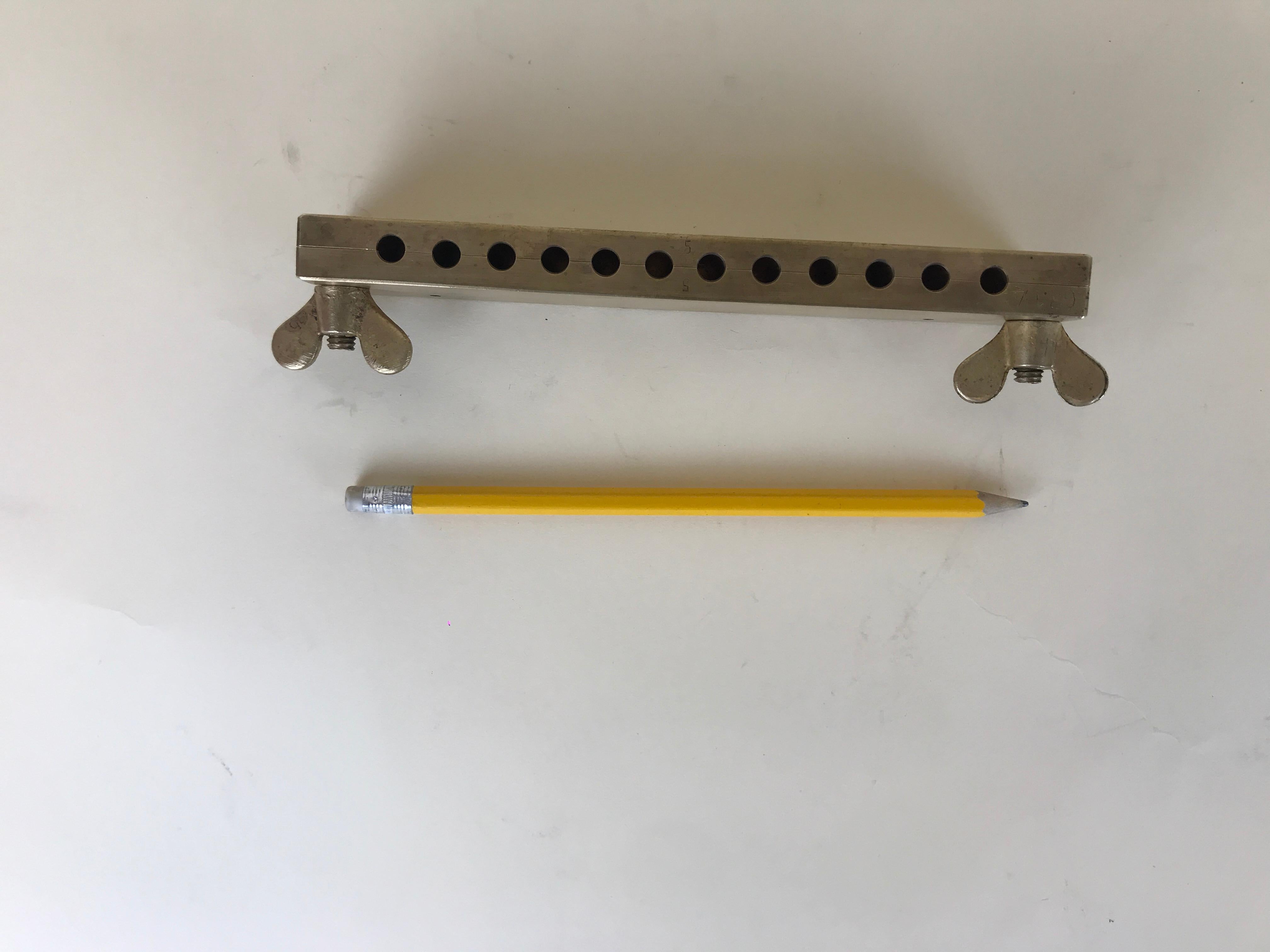 Vintage mold in brass for suppository of 1 g or 1.5 g made in Italy in the 1950s.

Dimension:

metal body 

19.5 x 1.5 x 3.5 cm 

butterfly bolts

3.7 cm long.


    