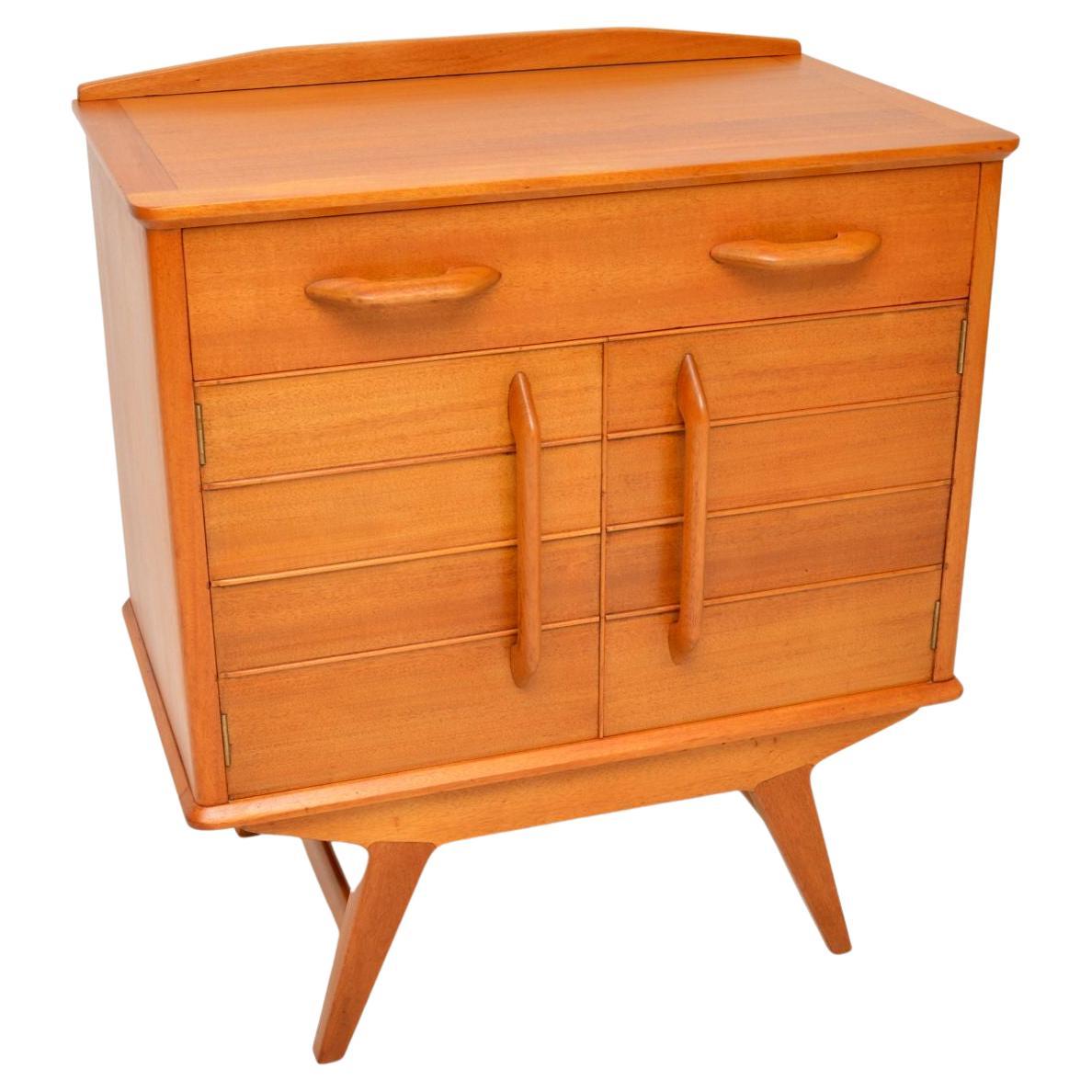 A very stylish and quite rare bureau dating from the early 1950’s. This was made in England by E Gomme, which a short time after became G Plan.

It is of superb quality and has a very useful design. It sits on beautifully splayed legs, contains a