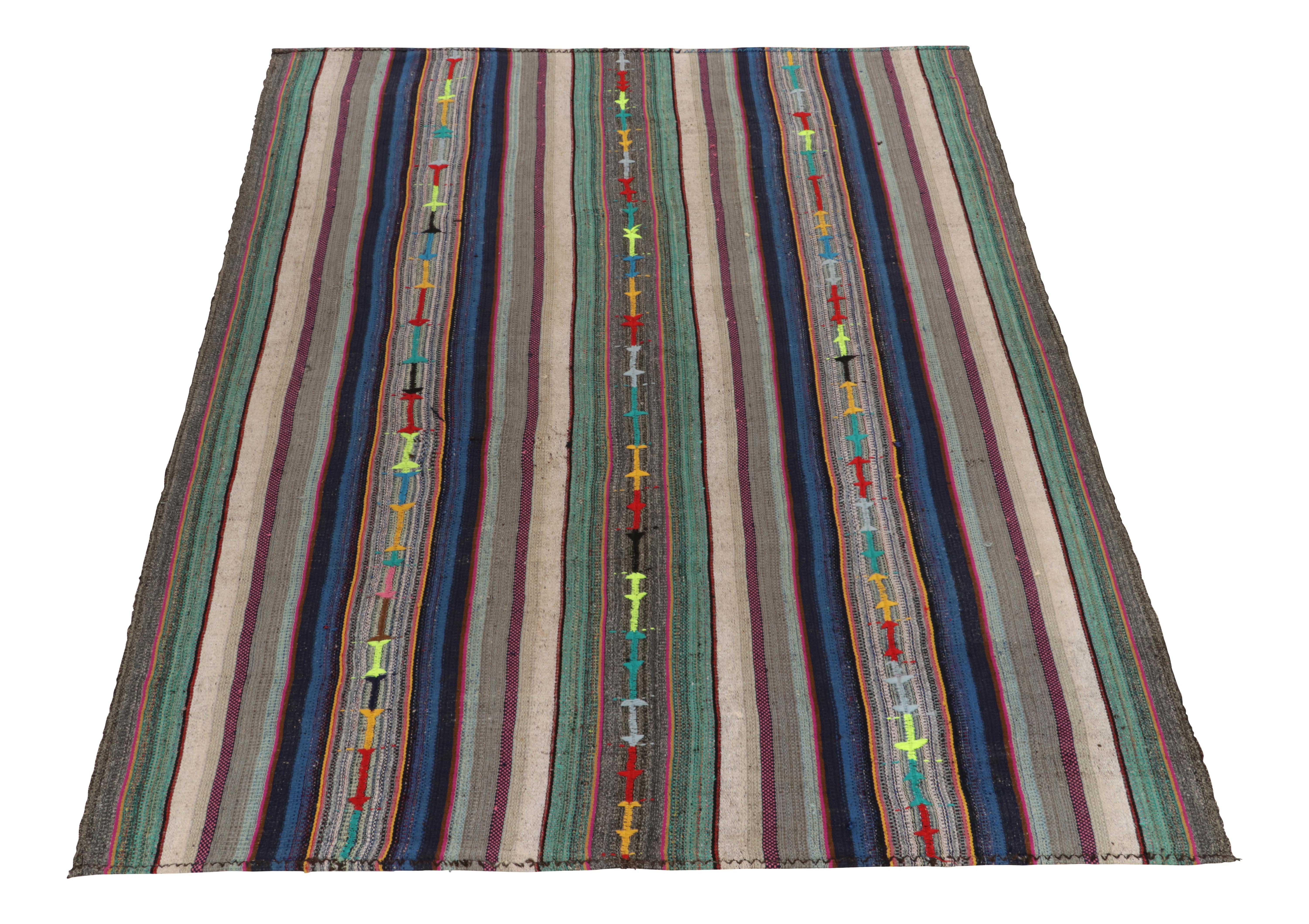 Originating from Turkey circa 1950-1960, a rare type of mid-century chaput kilim rug entering our classic flat weave curations. Characterized by fine detailing with the colors within the polychromatic stripes, the light & refreshing piece welcomes a