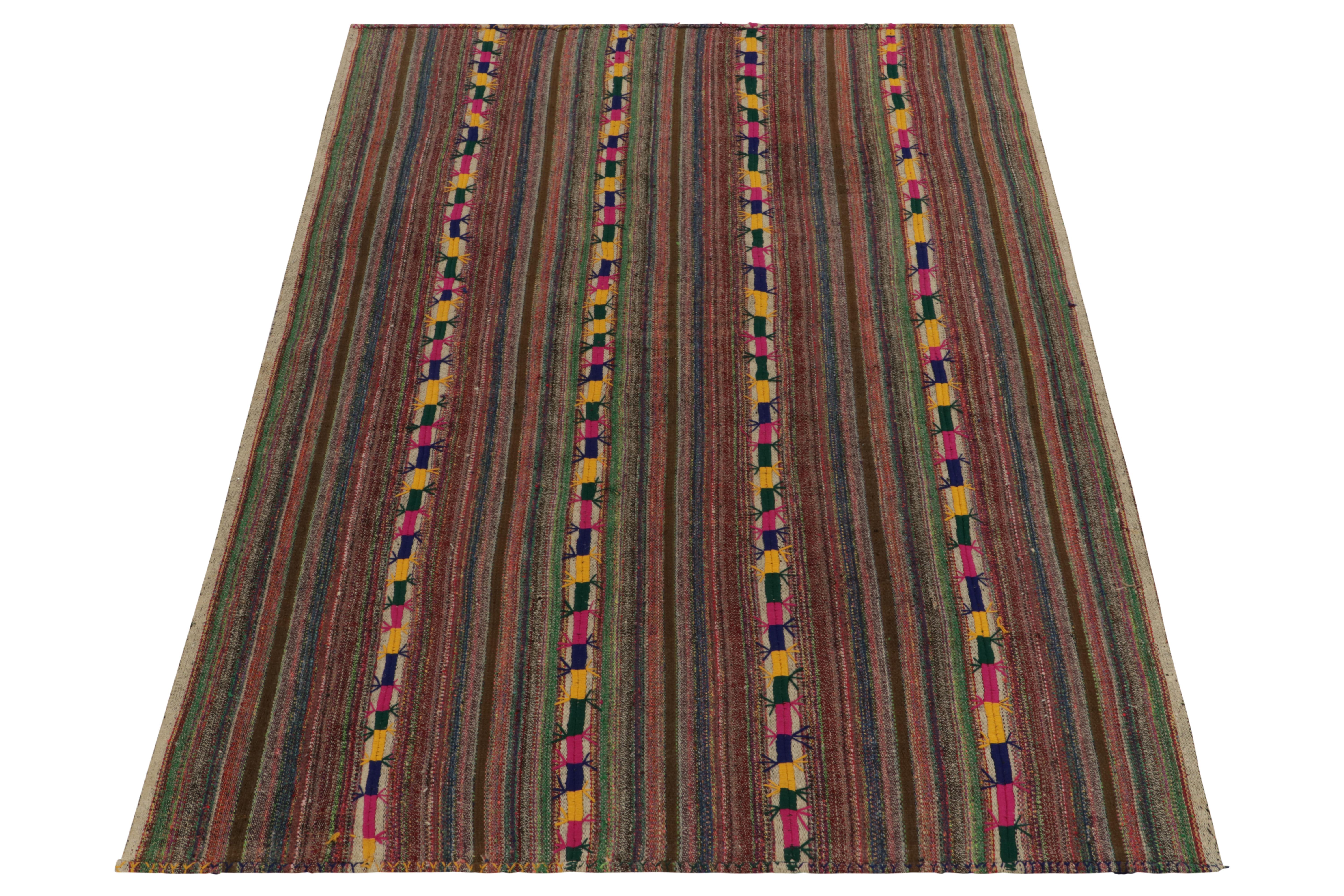Originating from Turkey circa 1950-1960, a rare type of chaput kilim rug style now entering our Antique & Vintage selections. Characterized by fine detailing with the colors within the polychromatic stripes, the playful piece welcomes a departure