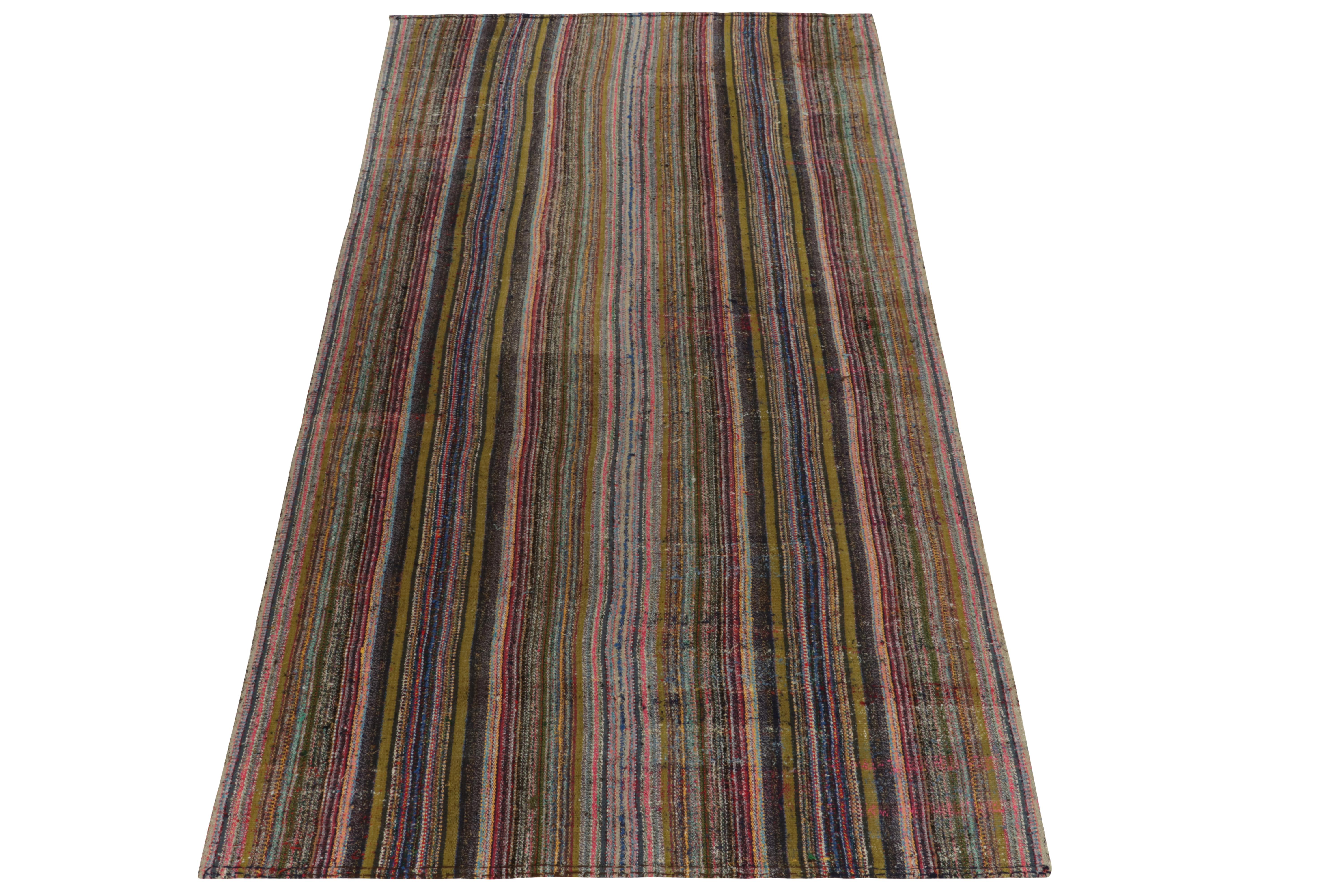 Originating from Turkey circa 1950-1960, a rare type of chaput kilim rug style making way to our Antique & Vintage selections. Characterized by fine detailing with the colors within the polychromatic stripes, the quiet piece welcomes a departure