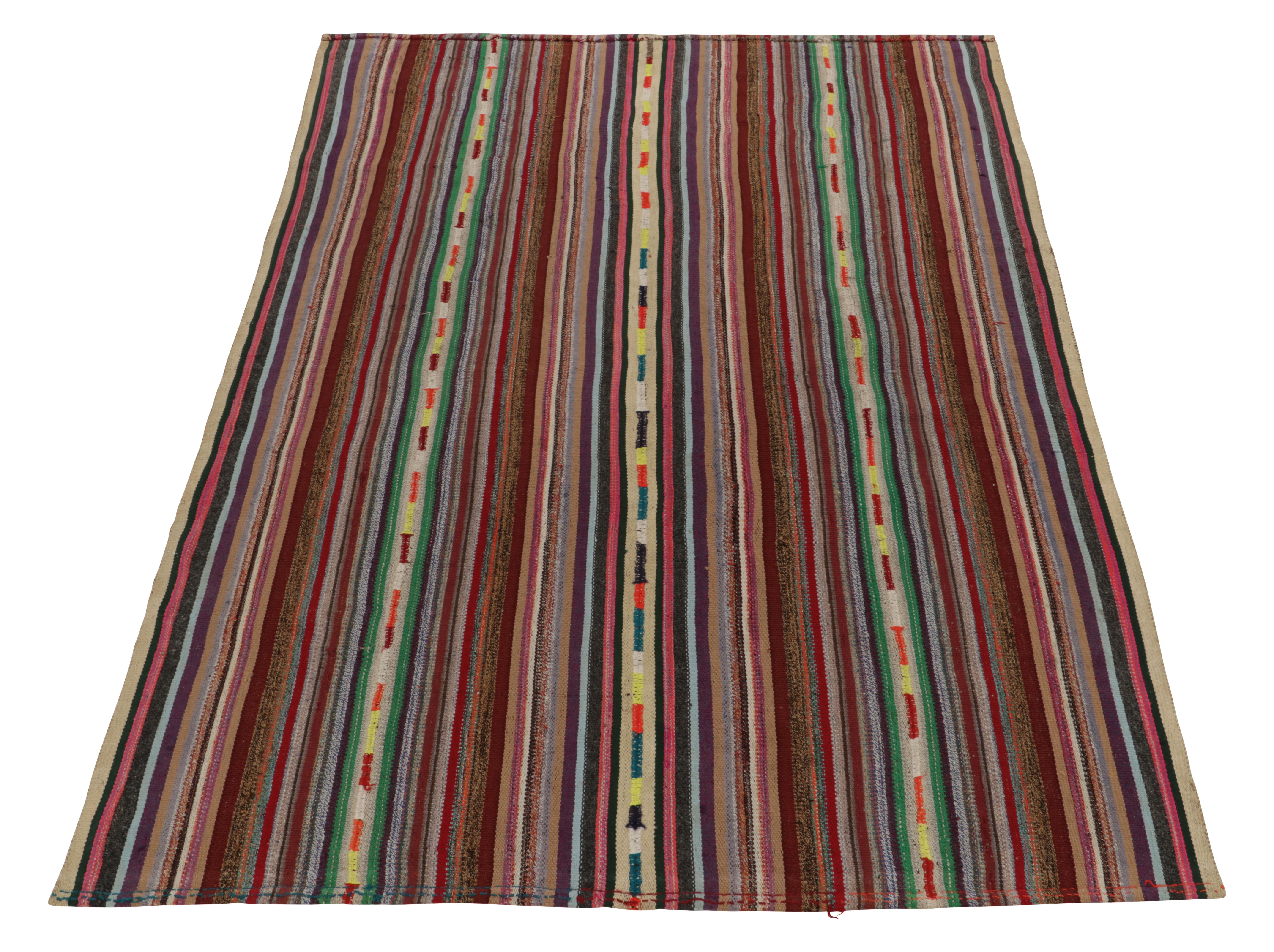 Originating from Turkey circa 1950-1960, a rare type of chaput kilim rug style now entering our vibrant classic selections. Characterized by fine detailing with fabulous colors within the polychromatic stripes, offering a departure from traditional
