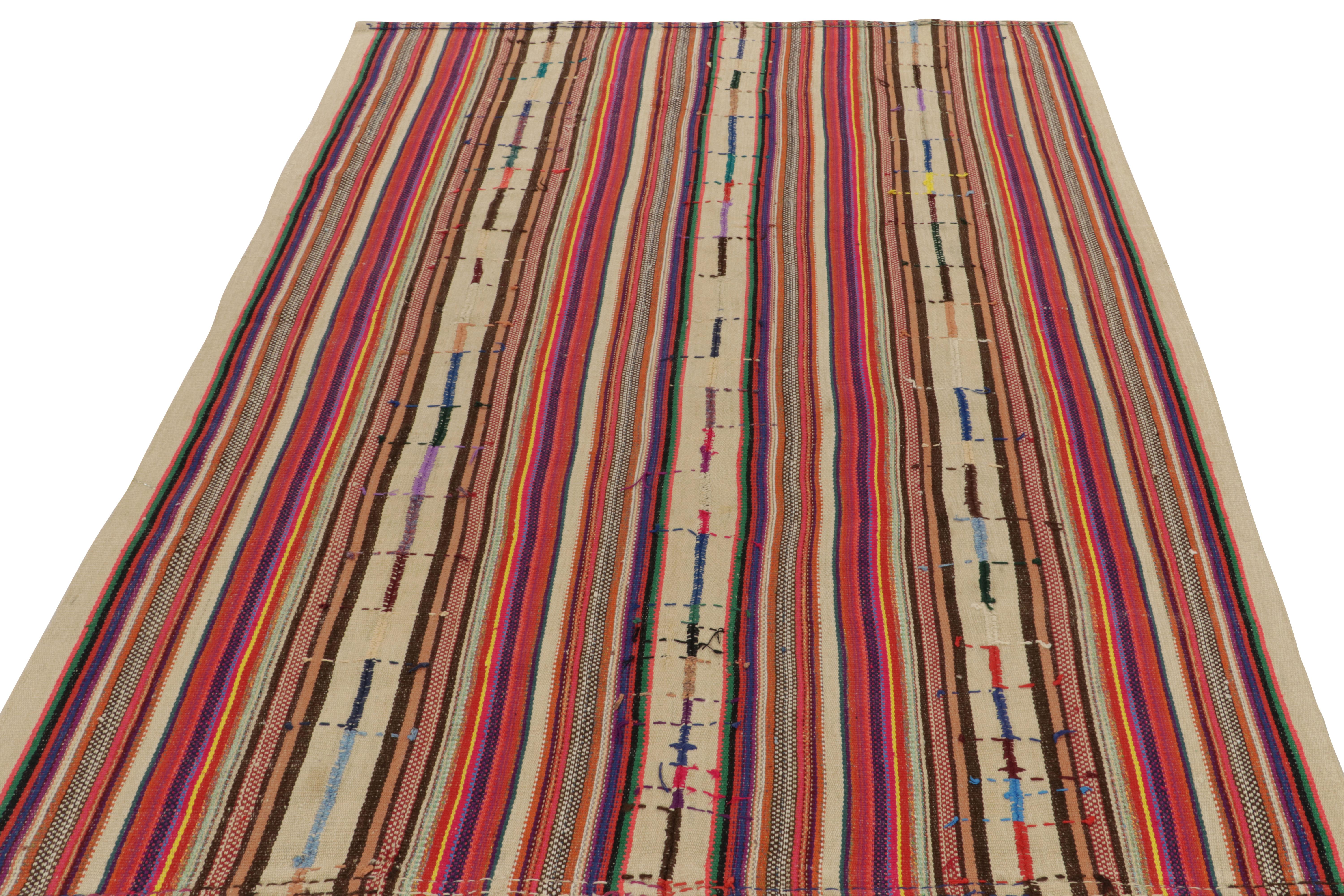 Originating from Turkey circa 1950-1960, a rare vintage chaput kilim rug style now entering our mid-century selections. 
Characterized by fine detailing with the colors within the polychromatic stripes, the lovely piece invites a departure from