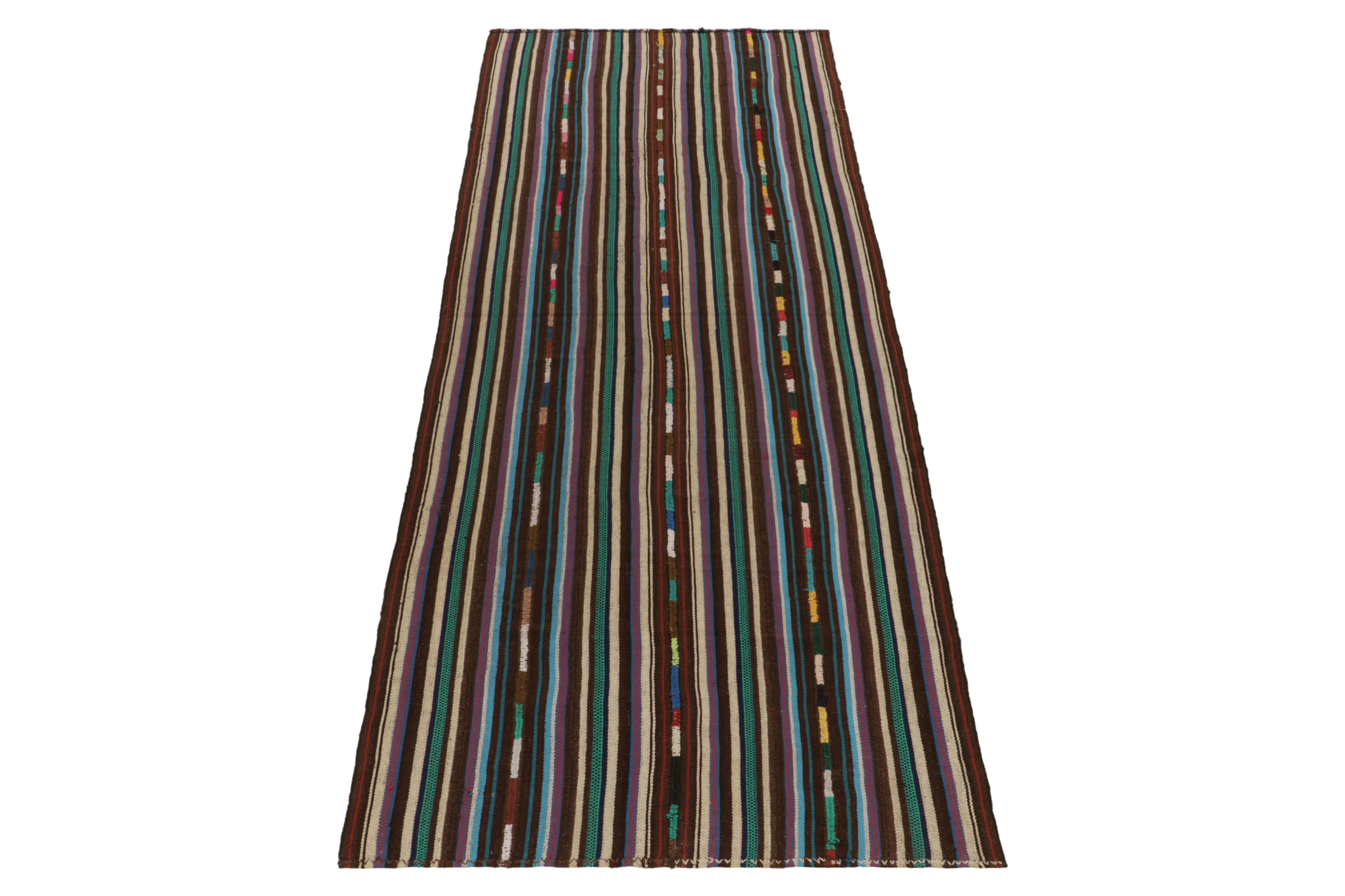 From Turkey circa 1950-1960, an exclusively curated mid-century chaput kilim style now entering our vintage flat weave rug selections. Boasting fine detailing with the colors within the polychromatic stripes, the quiet piece plays predominantly in