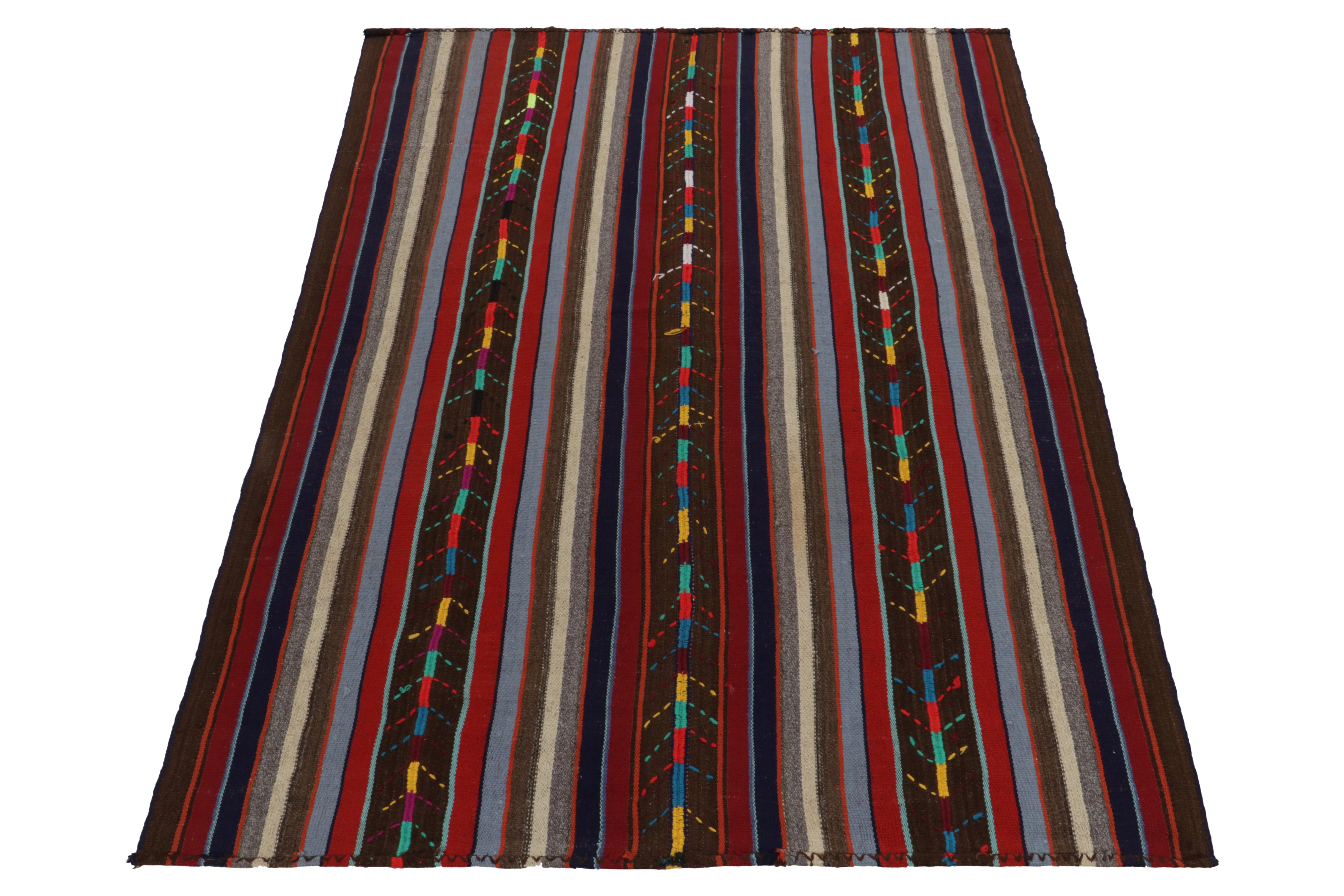 Handwoven in Turkey circa 1950-1960, this 6x8 vintage Chaput style Kilim rug enjoys a one of a kind approach in weaving. Featuring polychromatic striations in brown, red, white, blue, the flatweave dons a mature appeal seldom seen in this style.