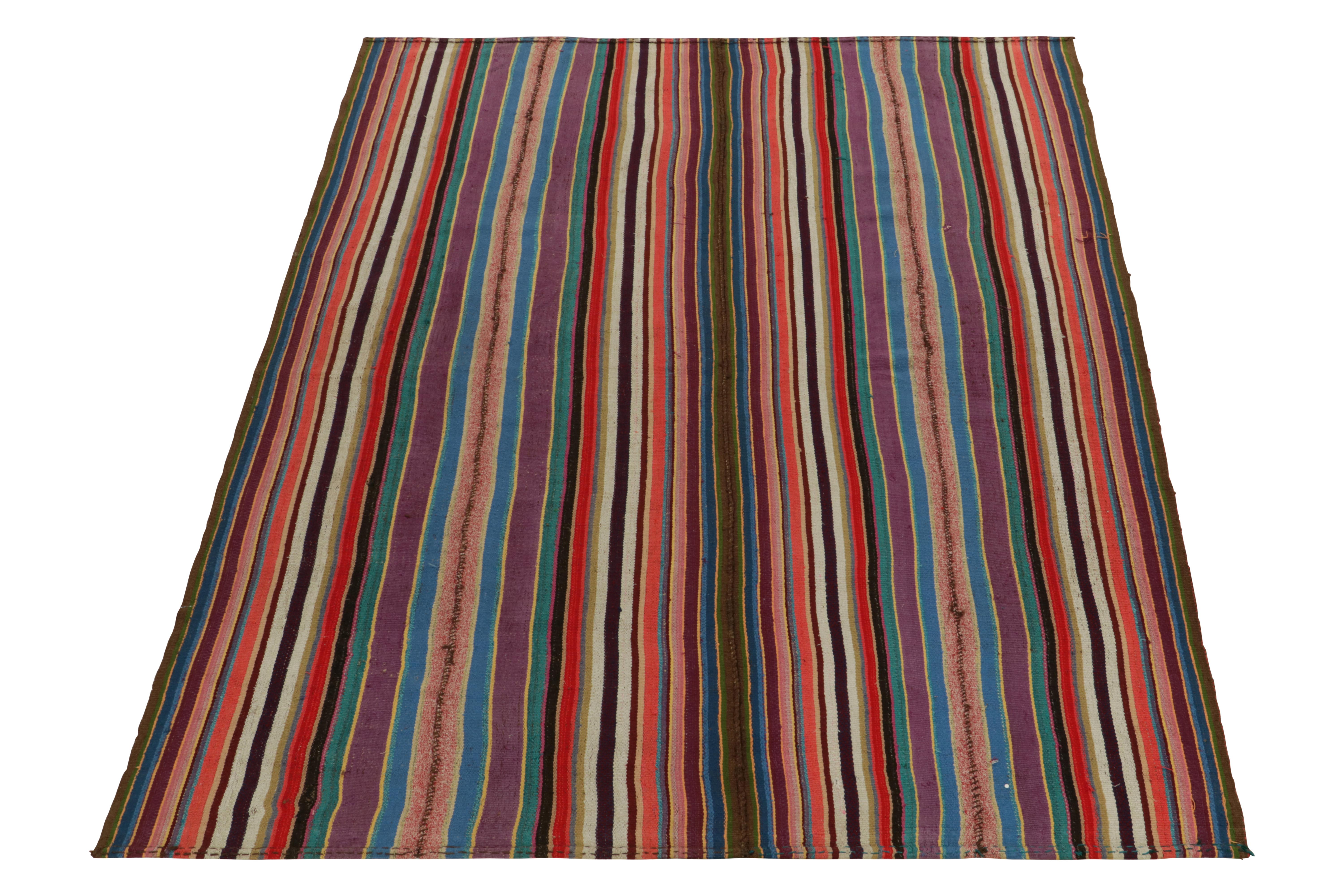 Originating from Turkey circa 1950-1960, a rare type of chaput kilim rug style now entering our Antique & Vintage selections. Characterized by fine detailing with the colors within the polychromatic stripes, the psychedelic piece welcomes a