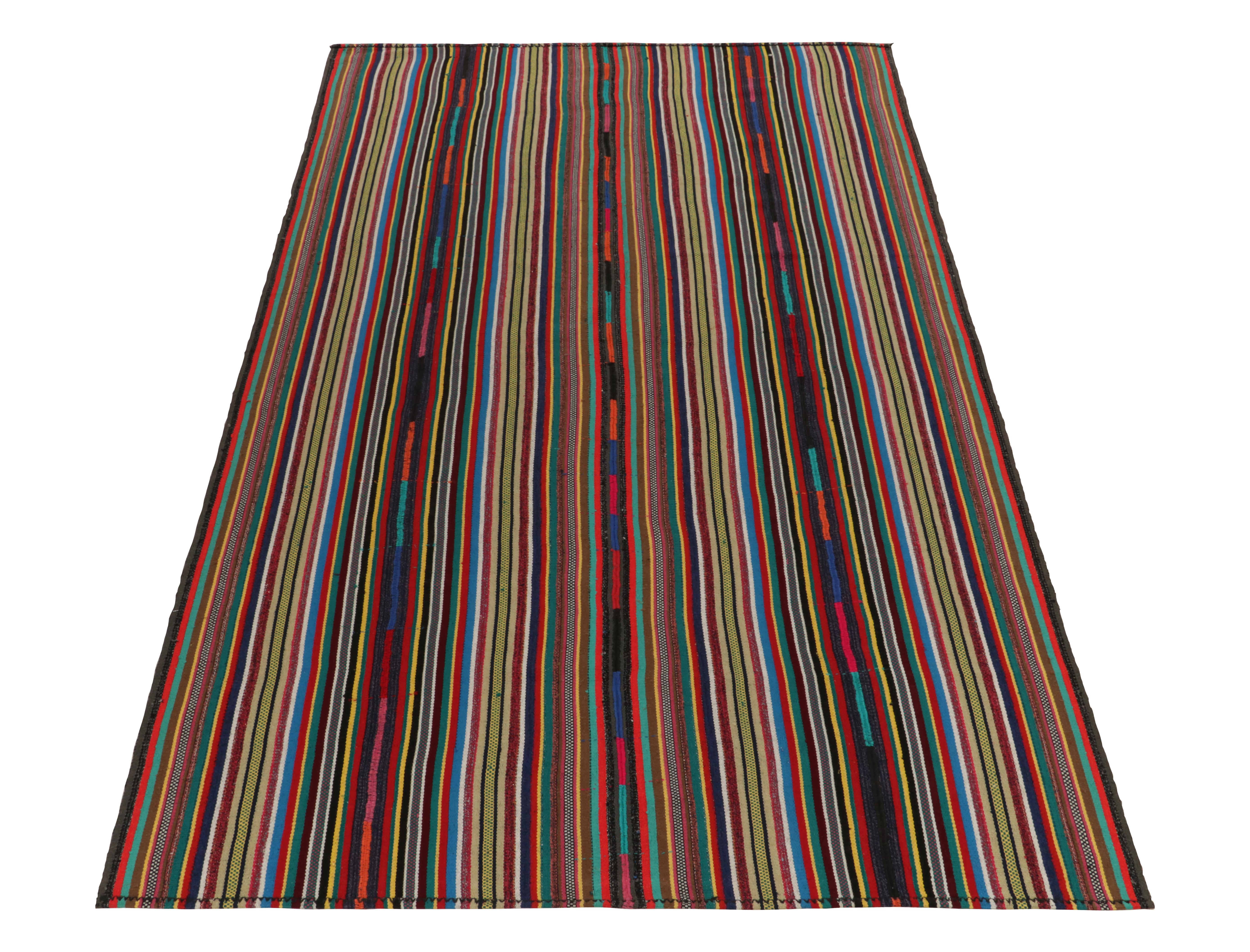 Originating from Turkey circa 1950-1960, a rare type of chaput kilim rug style now entering our Antique & Vintage selections. Characterized by fine detailing with the colors within the polychromatic stripes, the vibrant piece welcomes a departure