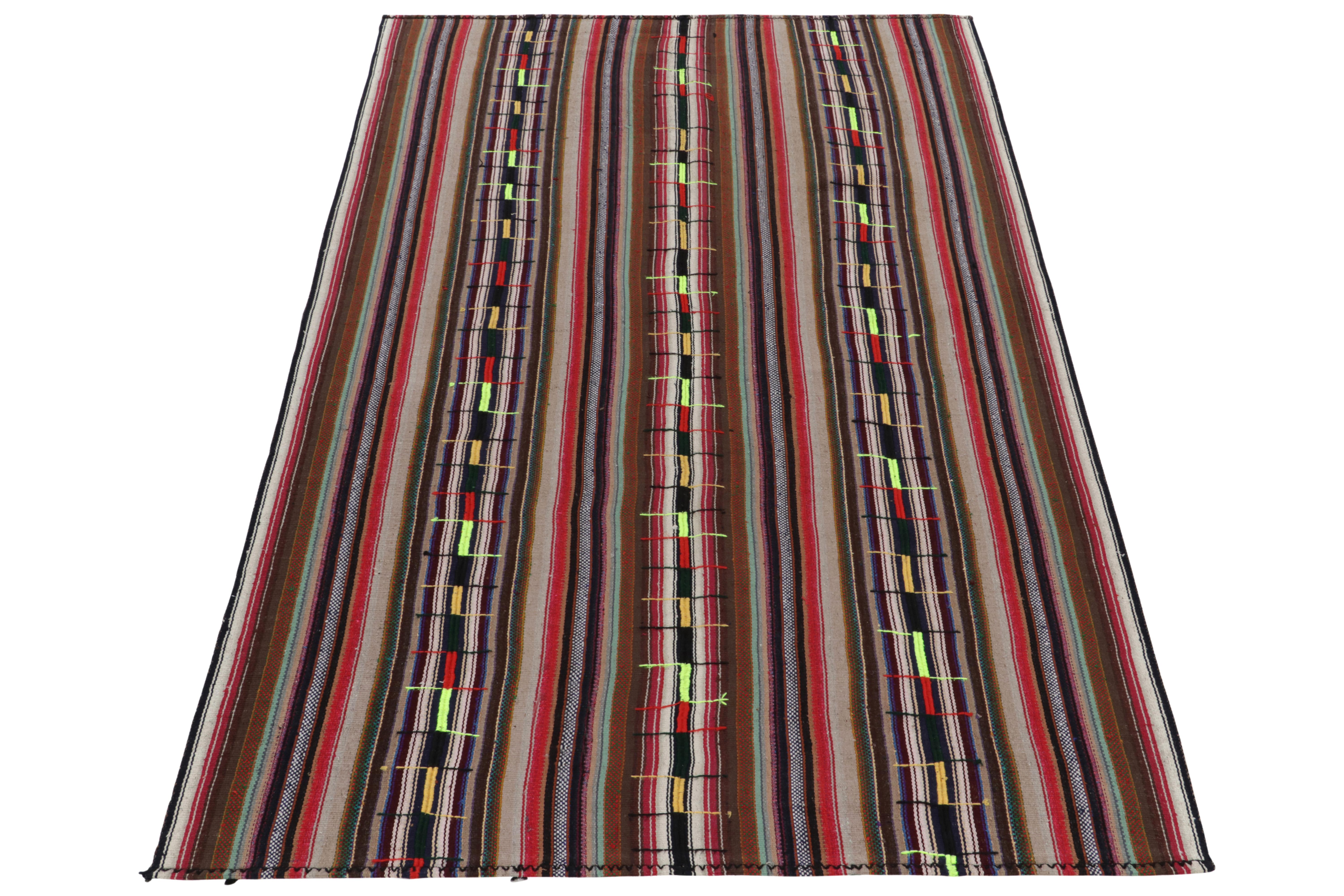 Originating from Turkey circa 1950-1960, a rare type of chaput kilim rug style now entering our Antique & Vintage selections. Characterized by fine detailing with the colors within the polychromatic stripes, the light & refreshing piece welcomes a