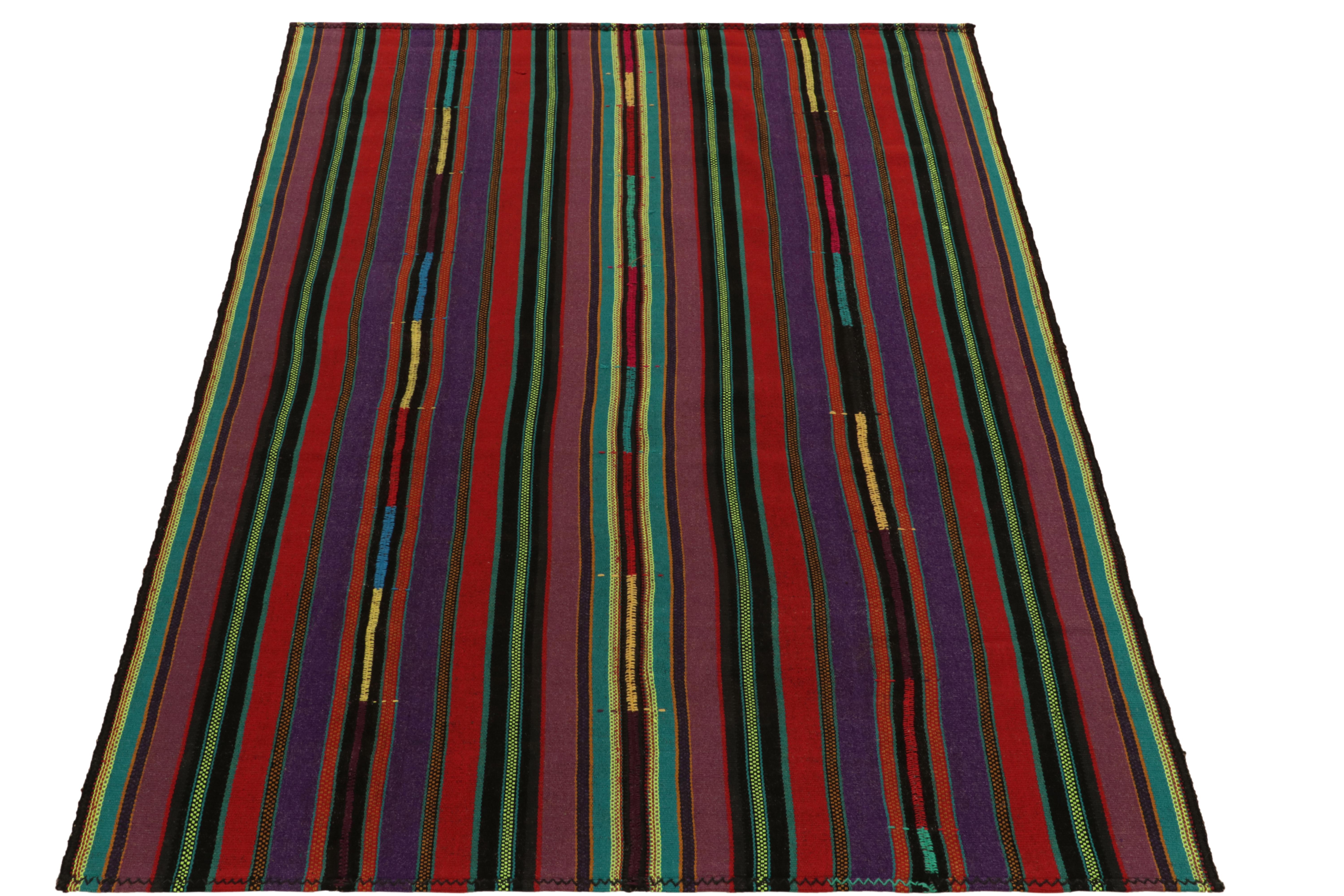 Hailing from Turkey circa 1950-1960, among a rare curation of mid-century chaput kilim rugs family in our collection. Characterized by fine detailing with the colors within the polychromatic stripes, the eccentric piece invites a departure from