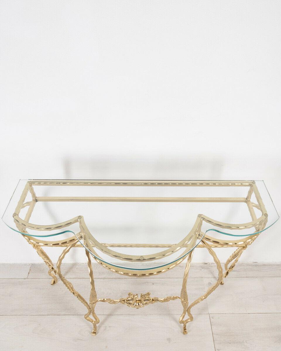 Consolle in gilded iron with transparent glass top, 1950s.
CONDITIONS: In good condition, it may show slight signs of wear due to time.

DIMENSIONS: Height 87 cm; Width 114 cm; Length 36 cm

MATERIALS: Iron and Glass

YEAR OF PRODUCTION:
