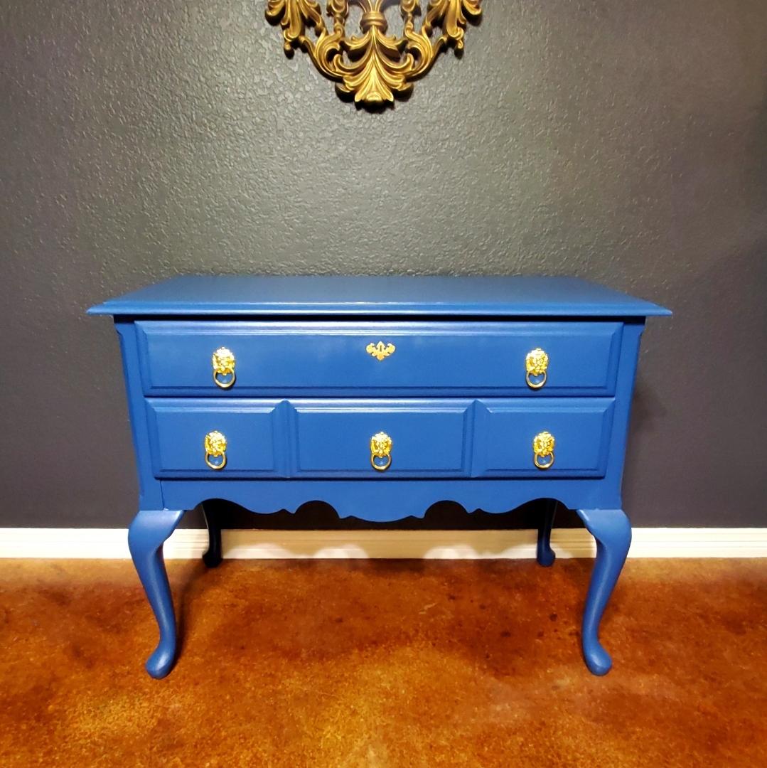 Statement piece.
Vintage piece custom painted the most beautiful custom blue.
Wood is solid under the paint. 
No veneers. 
Ball and claw feet.
Bright gold hardware. 
It's probably 60-80 years old based on the finish it had before. 