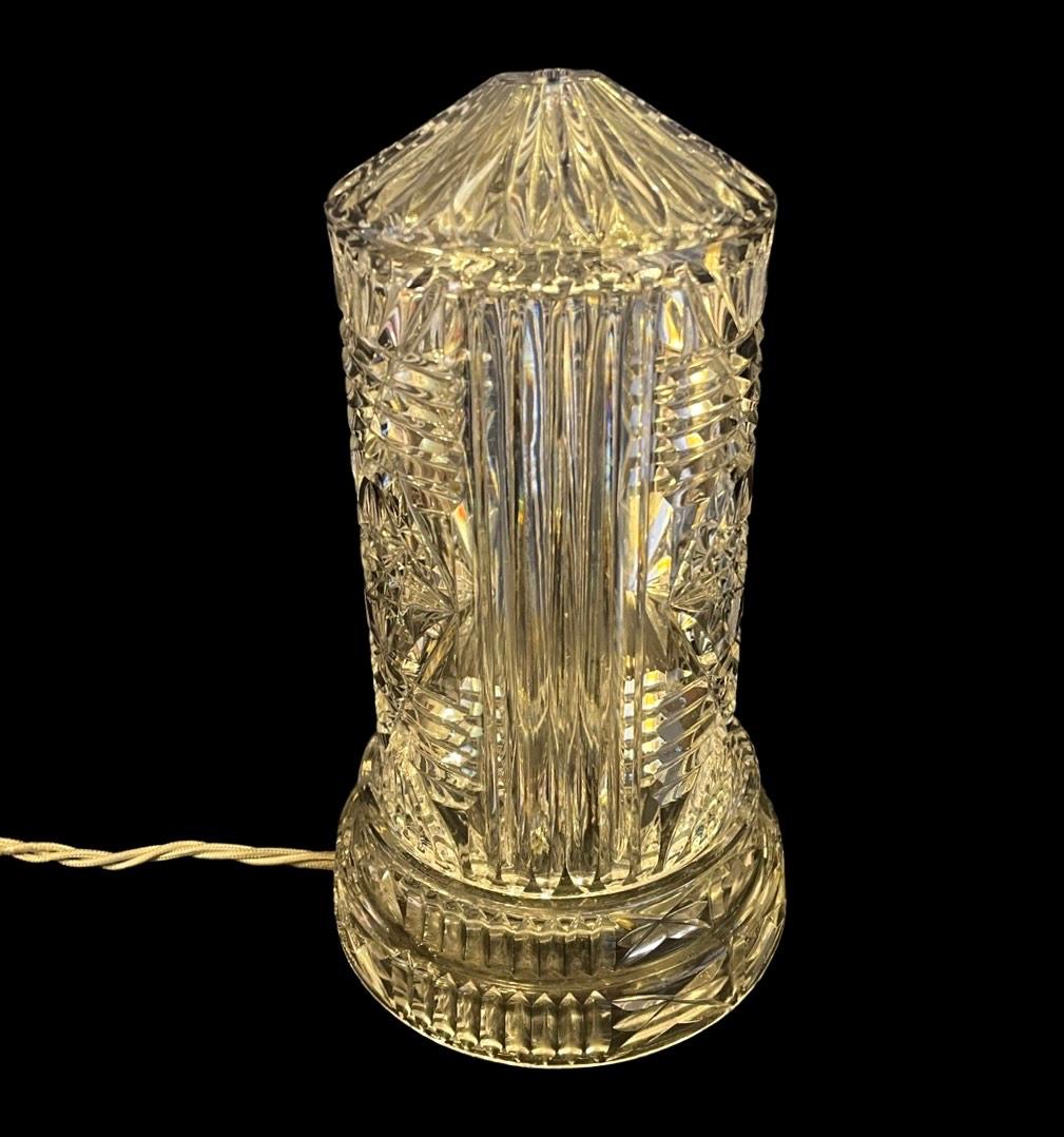 Unique 1950's Cut Crystal Tower Table Lamp.

A beautiful cut crystal design covers this piece with horizontal and vertical lines. 
An intricate star design pattern is featured in the middle of the light, the pattern has been replicated 3 times