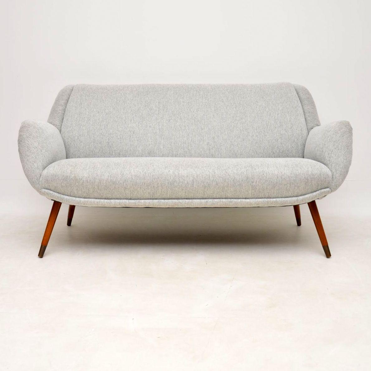 A beautifully designed and very comfortable vintage sofa, this was made in Denmark in the 1950s-1960s. It’s great quality, with a fantastic shape, it sits on sturdy brass capped tapered legs. We have had this completely re-upholstered in a lovely