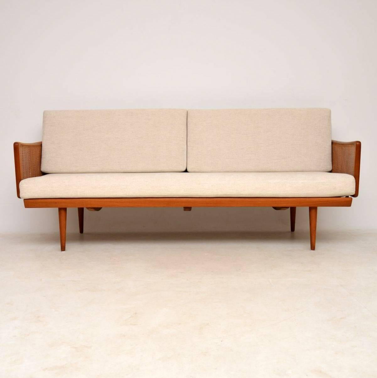 A stunning and very rare vintage Danish teak sofa, this was designed by Peter Hvidt and Orla Mølgaard-Nielsen. It was made by France and Daverkosen and it has the original badge intact, which means it can be dated to somewhere between 1953 and 1957