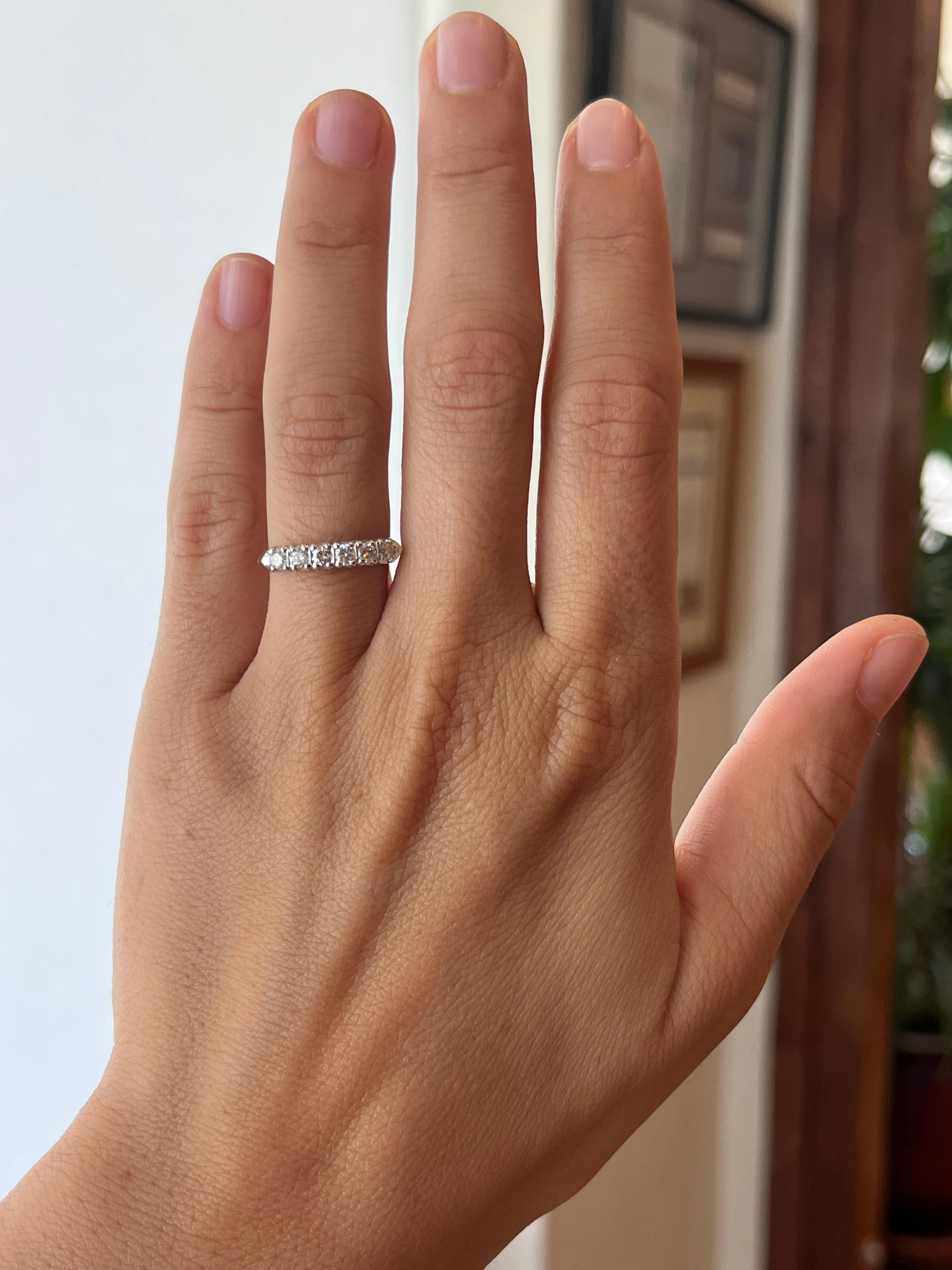 This genuine 1950s vintage diamond wedding band features 6 diamonds totaling 0.30cttw (VS1, H) in a platinum fishtail setting with a knife-edge shank. It measures 3.3mm at its widest and is size 5. It is one of many beautiful, timeless pieces from