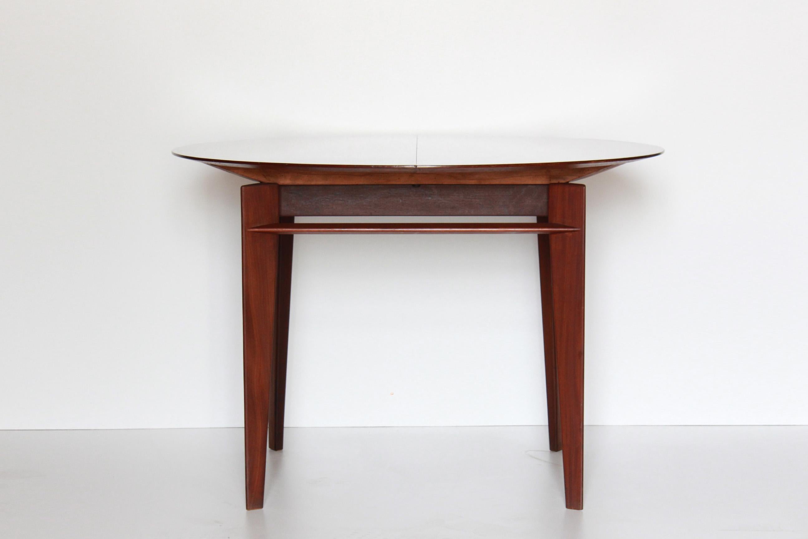 A rare round shaped 1950s vintage design dining table set in solid teak wood designed and manufactured by iconic italian Vittorio Dassi company.

Table: Extendible structure thanks to two extra panels, the table has a polished teak top and