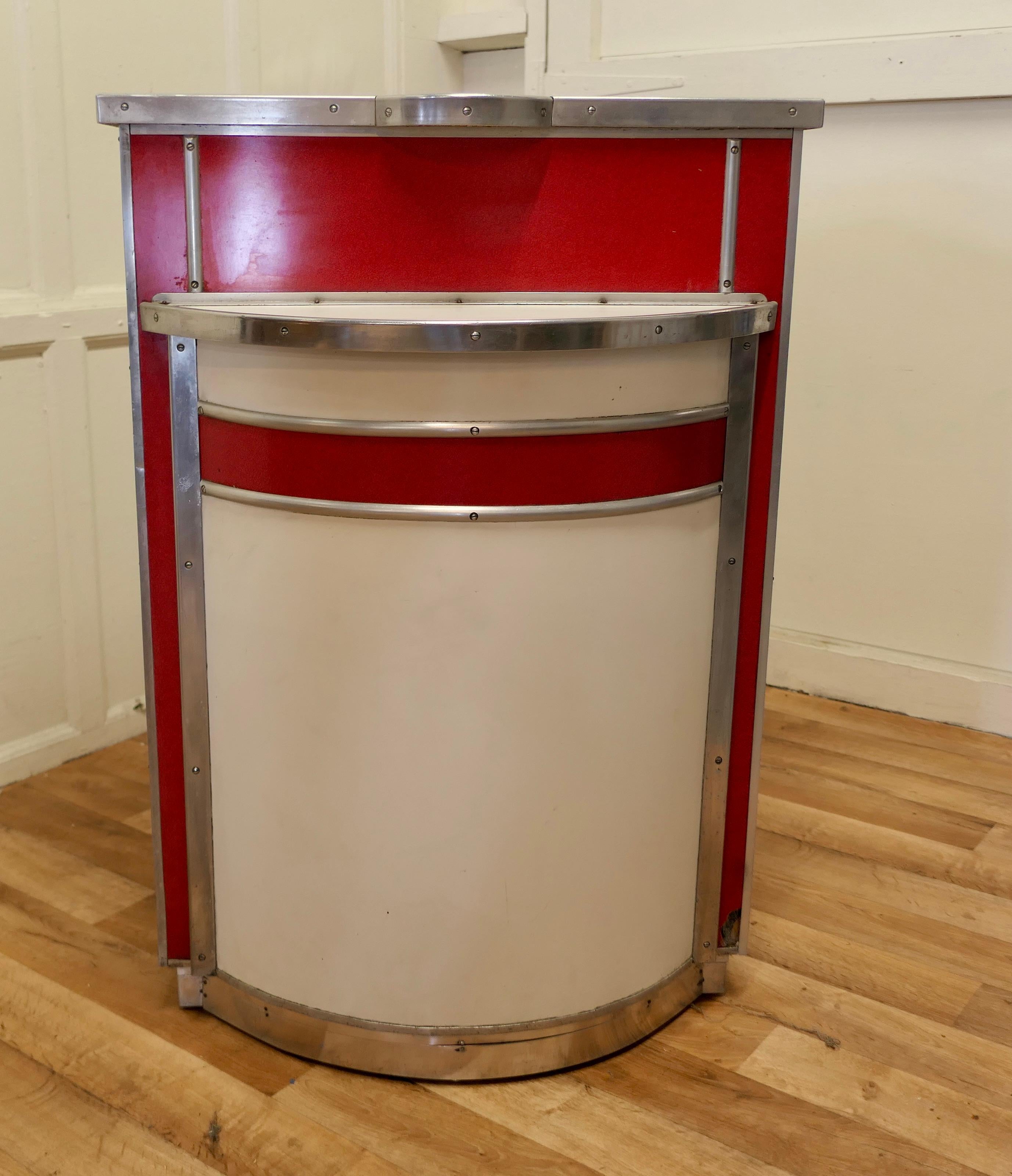 1950s Vintage Dry Bar Reception Desk Formica Diner Greeter

A superb and extremely rare piece, the greeter comes from a French Trucker’s Diner, it is finished in very striking Red and White Formica with a shiny aluminium  trim
The Classic design of