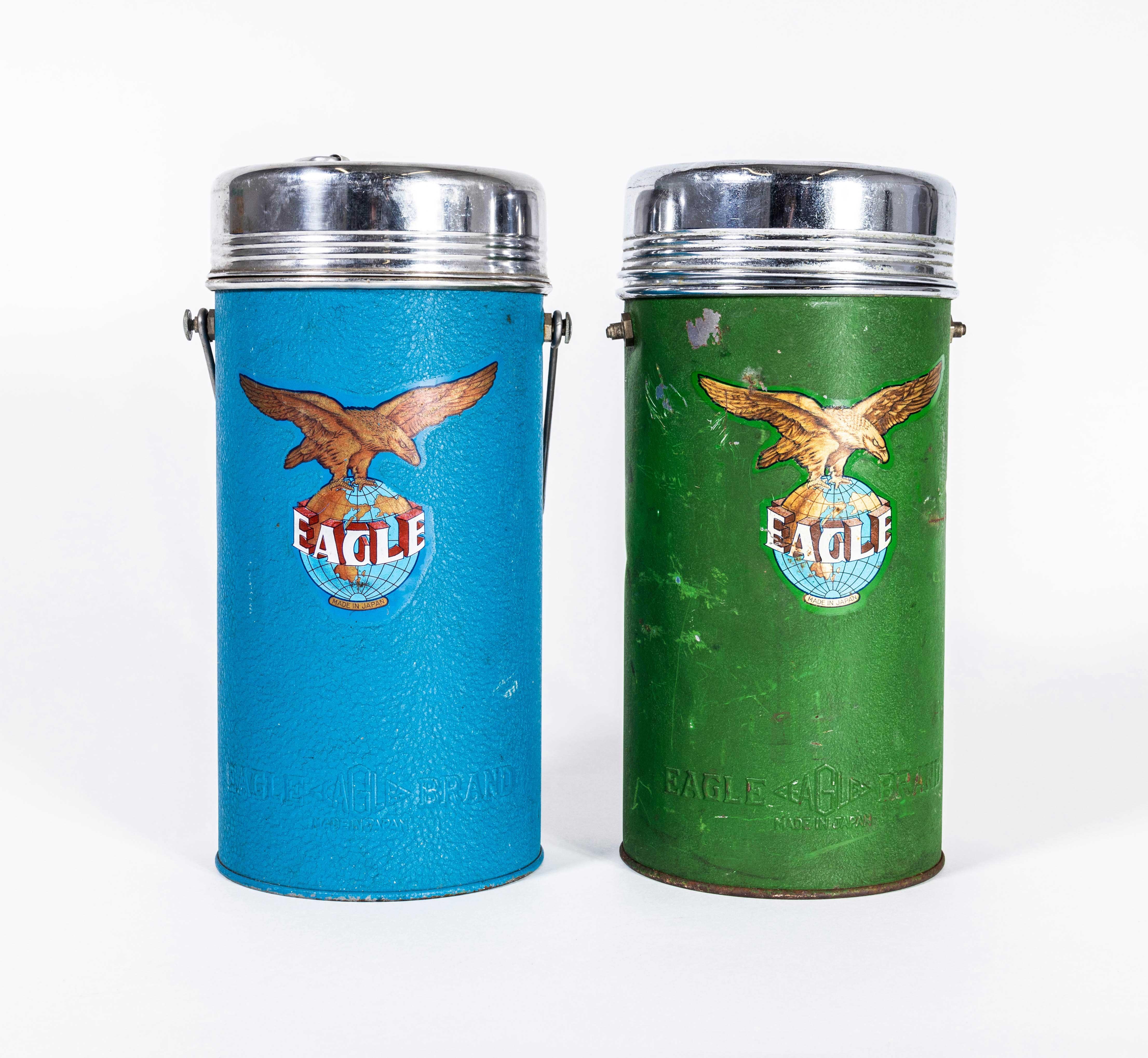 1950's Vintage Eagle Flasks - Pair. Founded in Japan Eagle flasks are considered the designers choice. 

Dating from the 1950's we are selling these as a decorative pair. Green flask is missing a handle and the blue flask has no internal lid. Glass