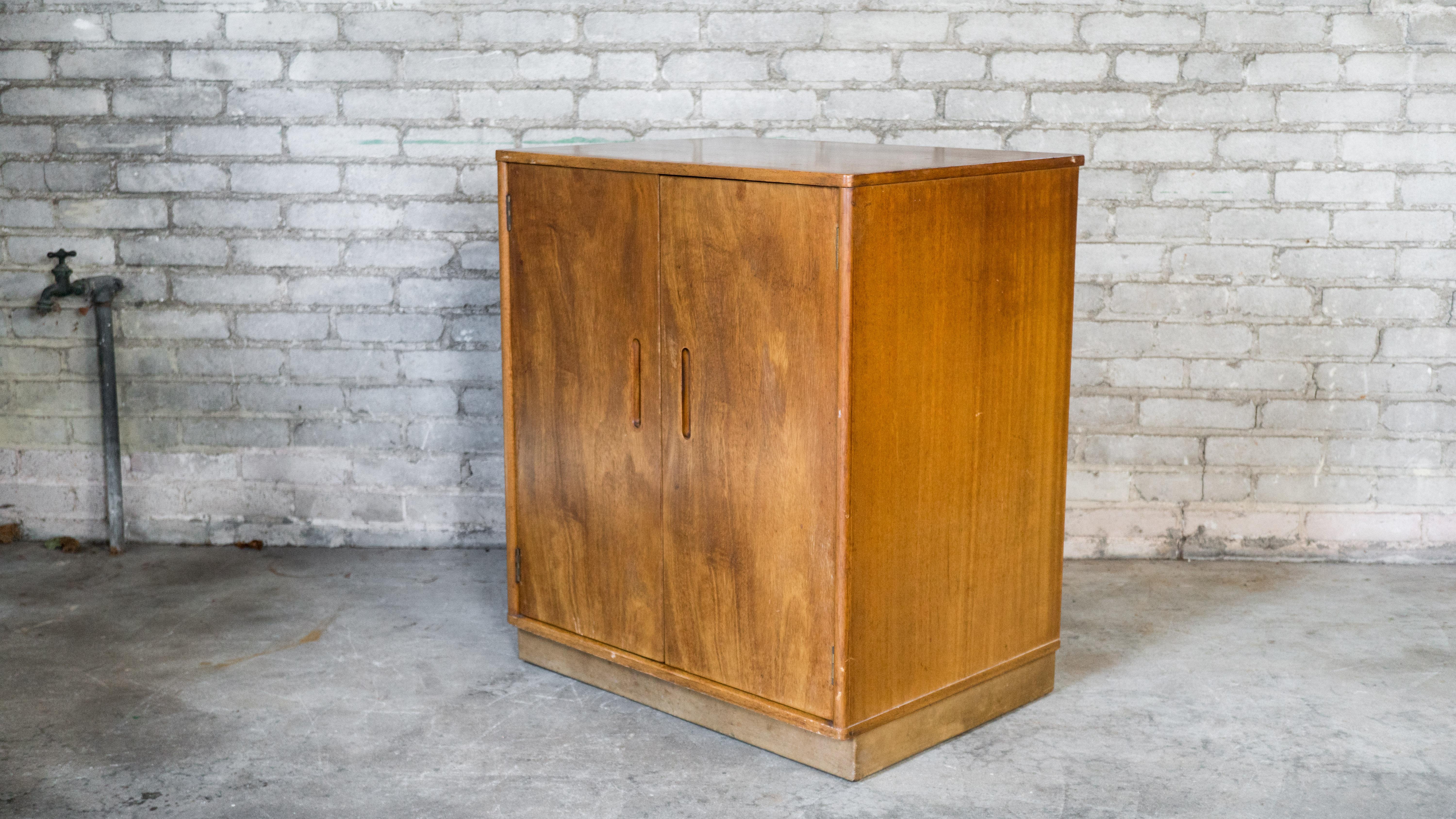 Edward Wormely for Dunbar cabinet, circa 1950s. Presented in mahogany, showing lovely woodgrain details. Two doors open to three adjustable selves. Perfect size for various uses. Metal notches keep doors in place when closed. Dovetail joints,