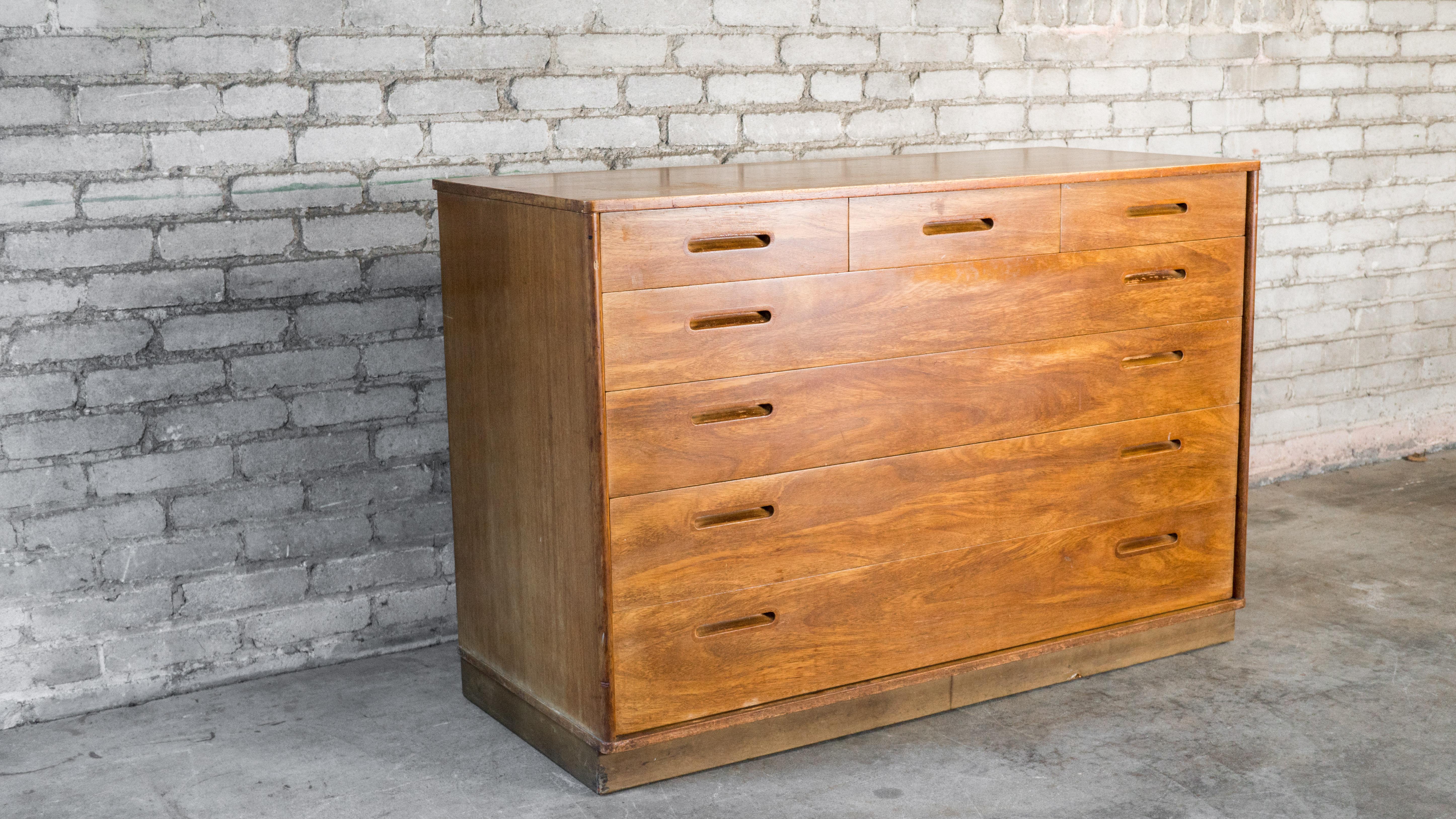 Edward Wormely for Dunbar dresser, circa 1950s. Presented in mahogany, showing lovely woodgrain details. Seven drawers with dovetail joints. Ample storage. Leather wrapped plinth base. Beautiful craftsmanship. Good vintage condition. Made in United