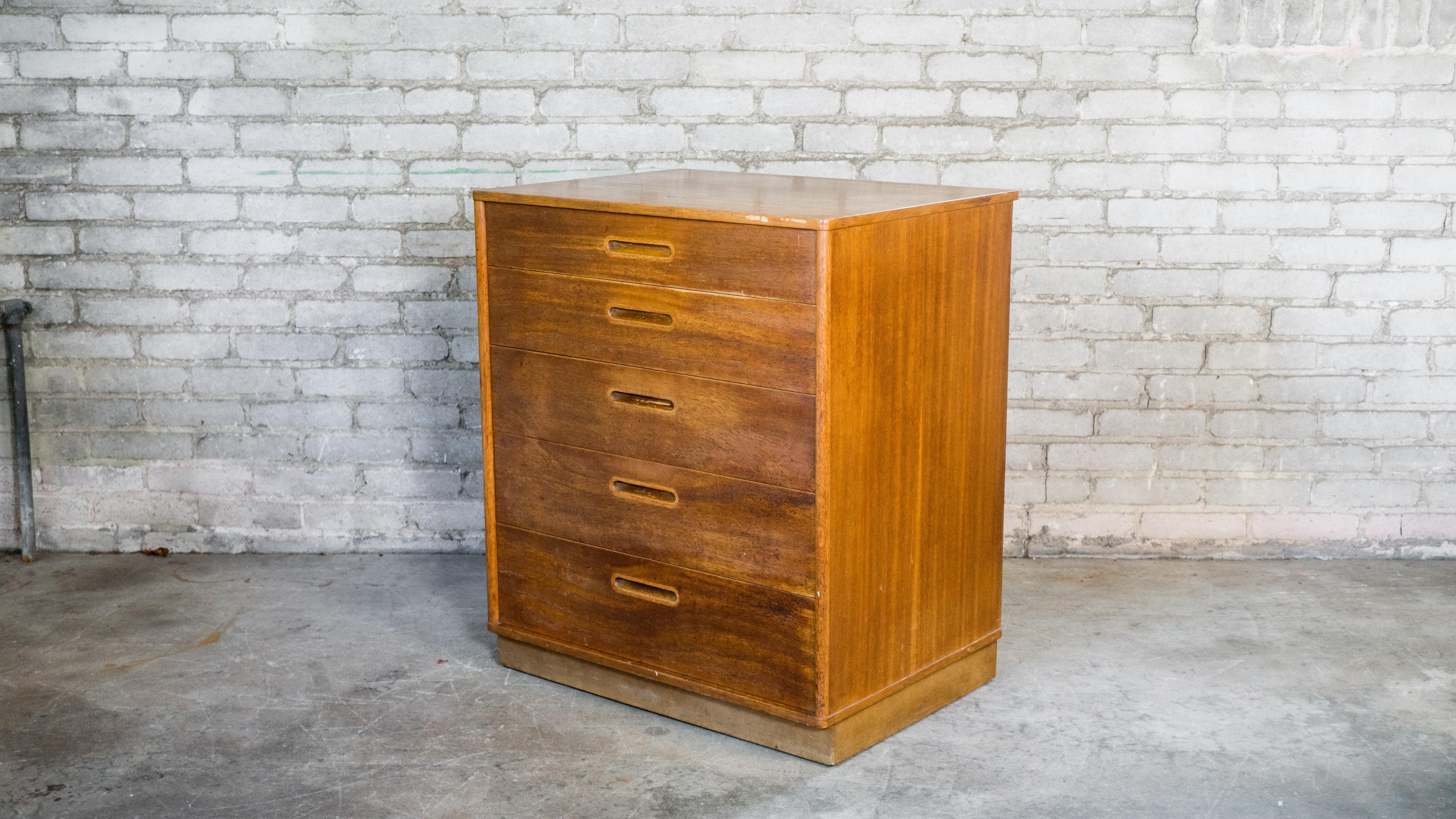 Edward Wormely for Dunbar dresser, circa 1950s. Presented in mahogany, showing lovely woodgrain details. Five drawers with dovetail joints. Perfect smaller size. Leather wrapped plinth base. Beautiful craftsmanship. Good vintage condition.