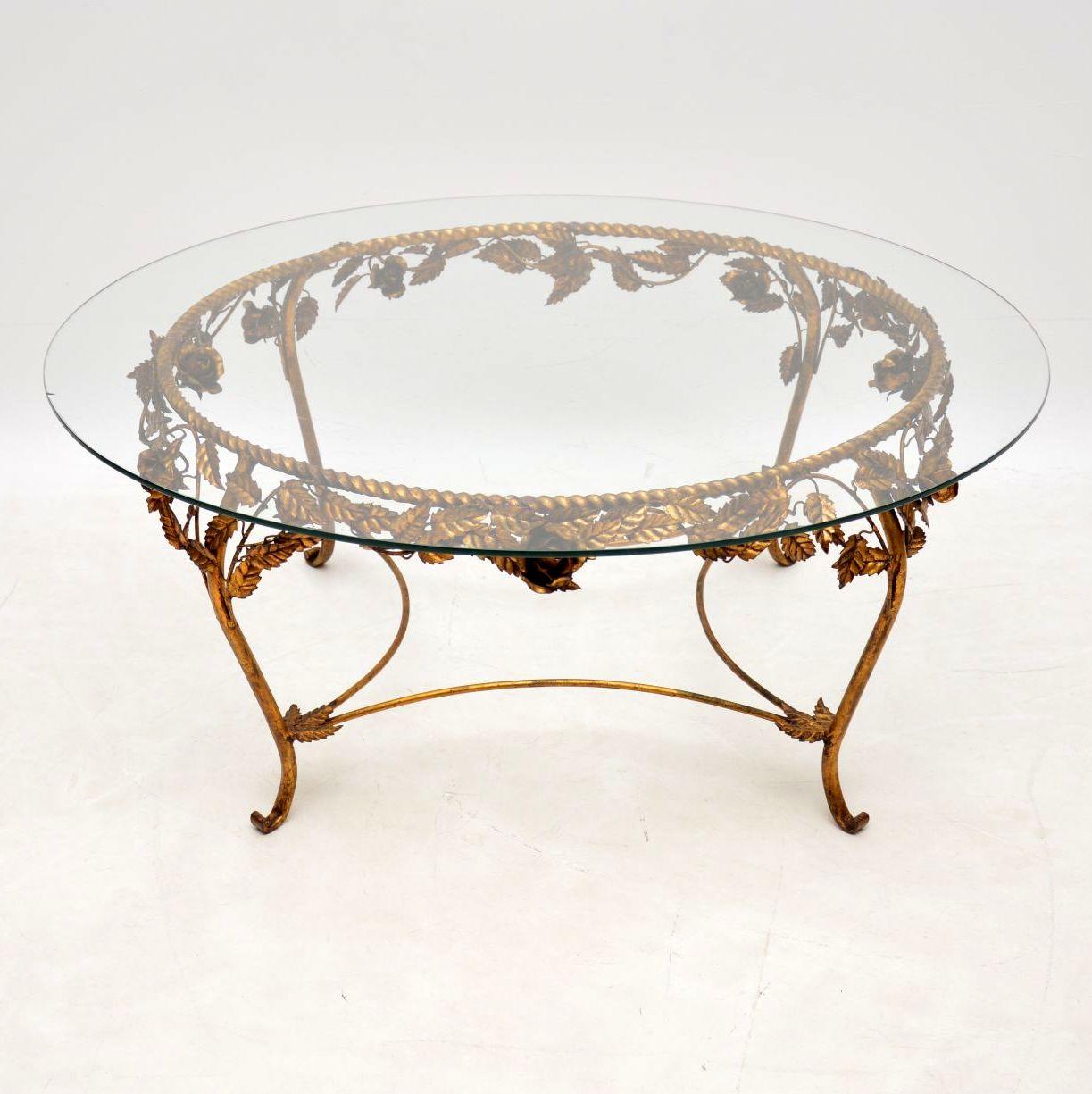 A stunning vintage coffee table made in France, this dates from around the 1950s-1960s. It is of superb quality, with a beautiful gilt metal frame in a floral design. The circular toughened glass top has been newly made in the exact same size as the