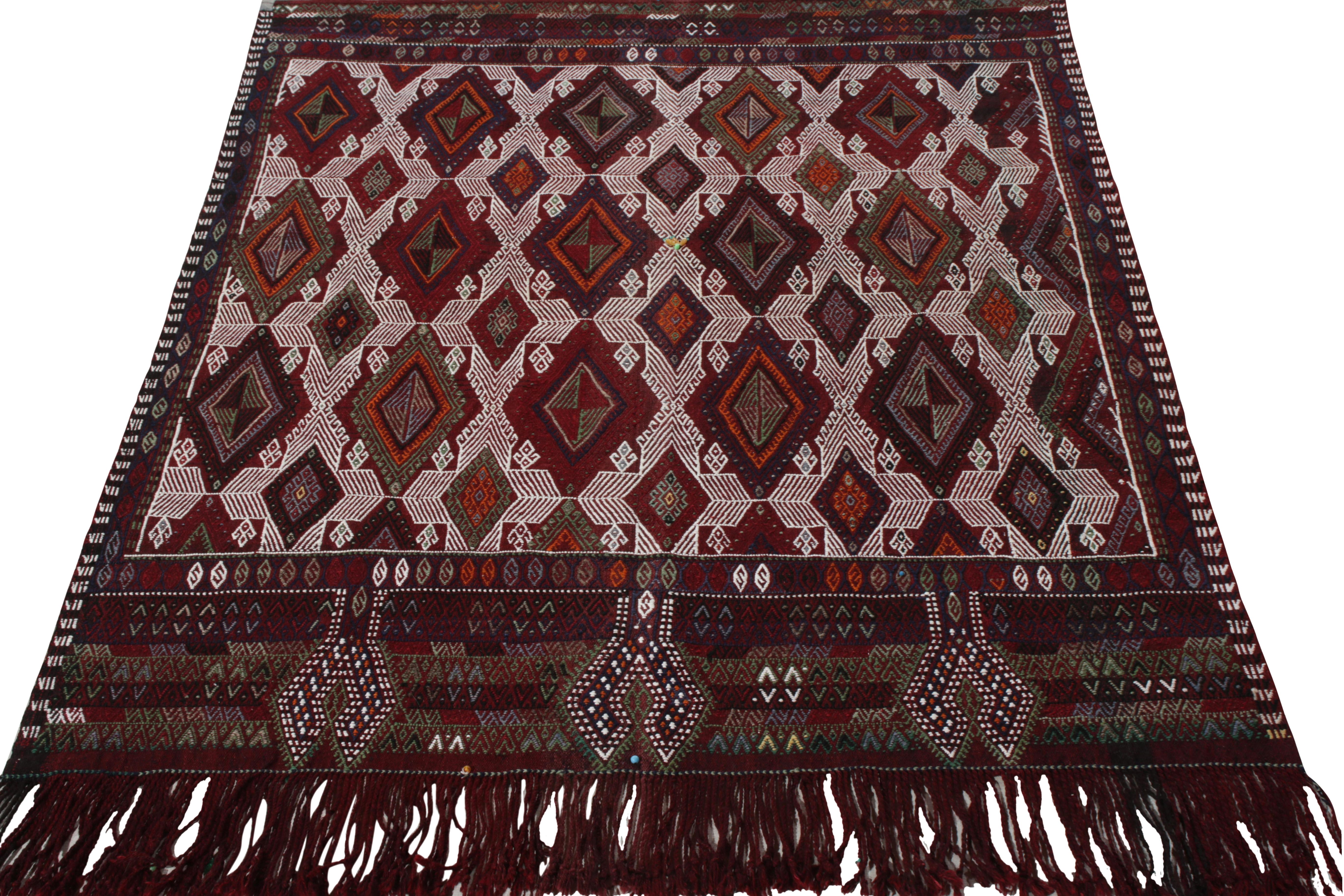 Dexterously woven in wool circa 1950-1960, this 1950s vintage Kilim piece hails from Rug & Kilim’s iconic Kilim & Flat Weave Collection. Covering a 4x5 near-square scale of Turkish tribal sensibilities, the rug features a symmetric geometric pattern