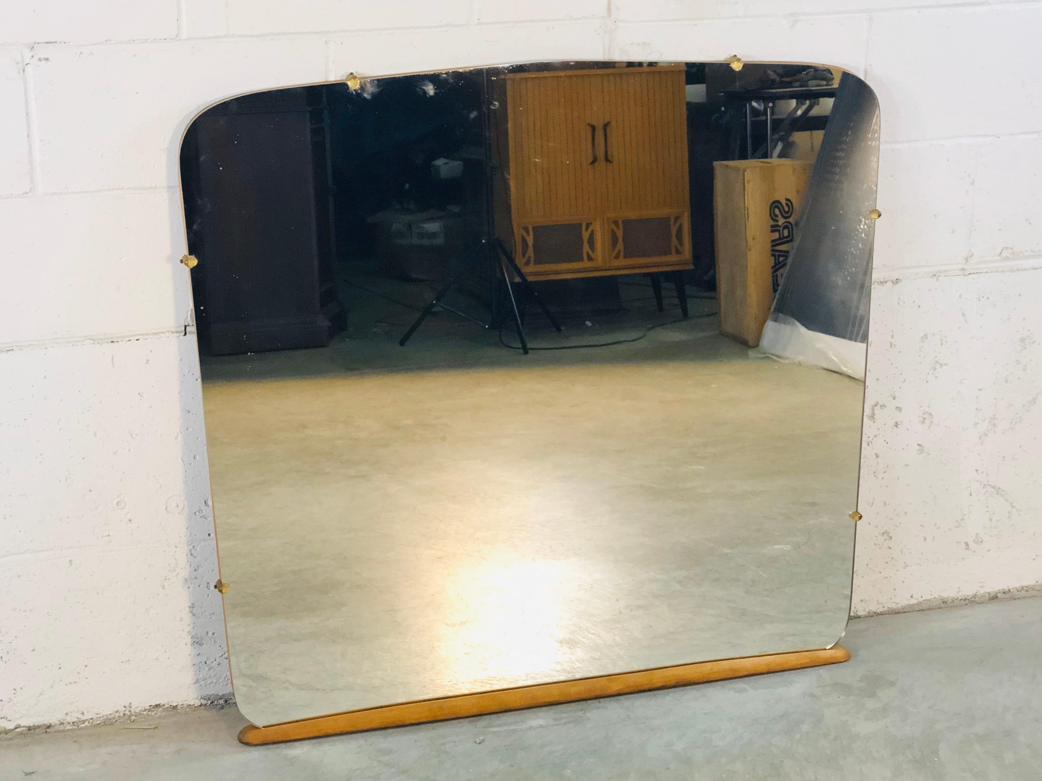 Vintage 1950s Heywood Wakefield mirror. May have originally been used on a vanity but could easily be used as a wall mirror today. The wood has been restored and the mirror is in excellent condition. No hardware. Marked on the back.