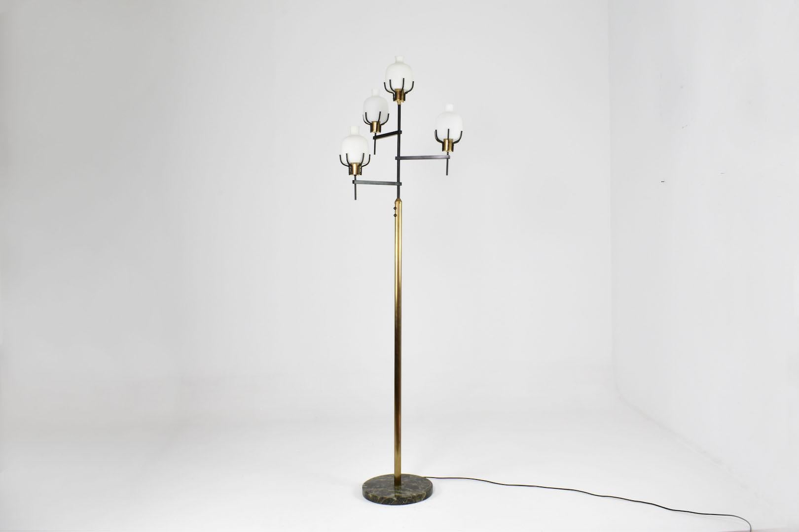 A stunning Italian 1950s mid-century modern floor lamp in the style of Angelo Lelii's work for Arredoluce. 

The lamp features a sculptural polished brass stem and is supported by a green marble base. 
The black lacquered asymmetrical branching arms
