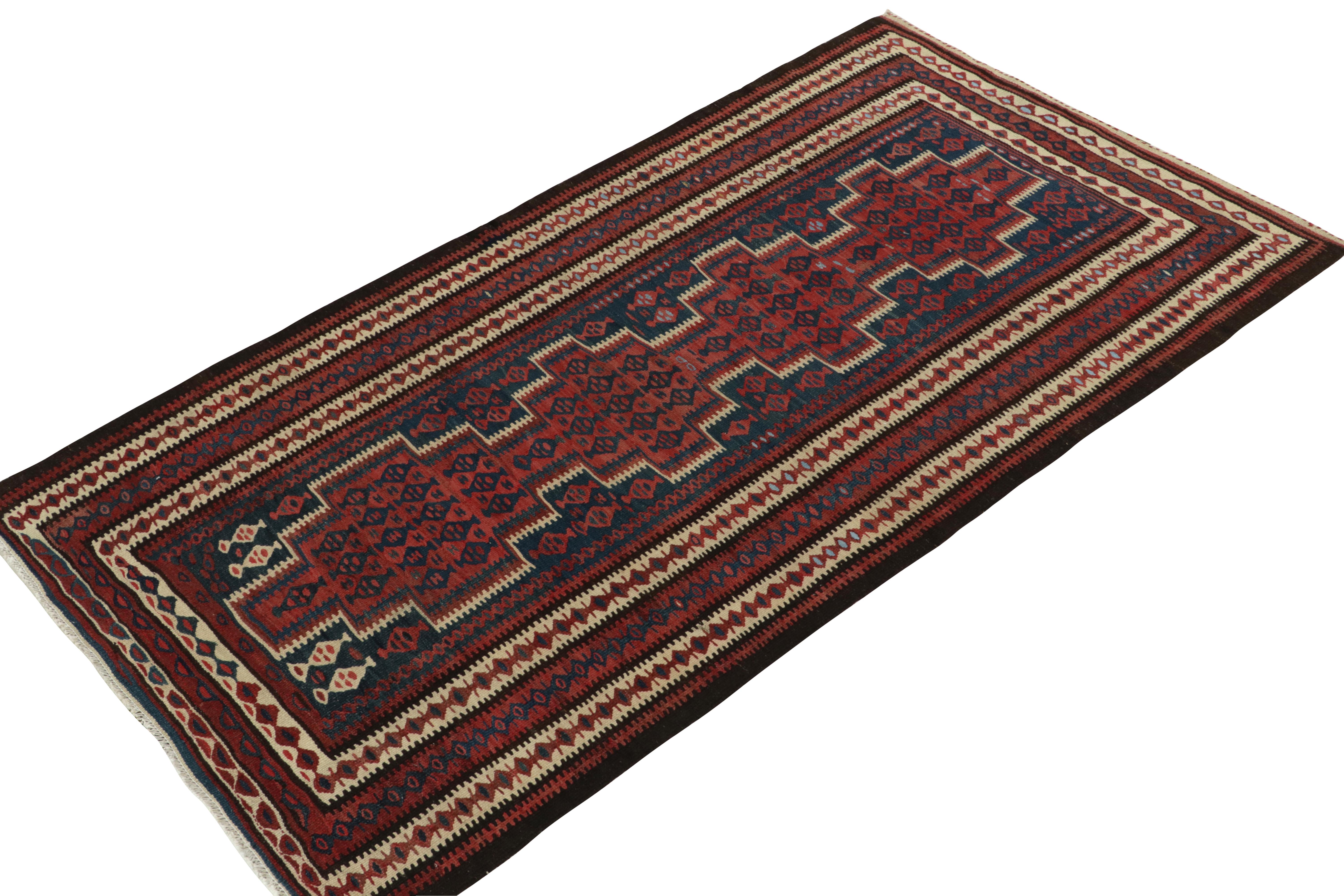 Originating from Turkey circa 1950-1960, a mid-century kilim rug enjoying a meticulous all over pattern. Featuring a well defined traditional pattern in red, blue & beige-brown with outstanding finesse, a 4x8 piece thriving in good condition well
