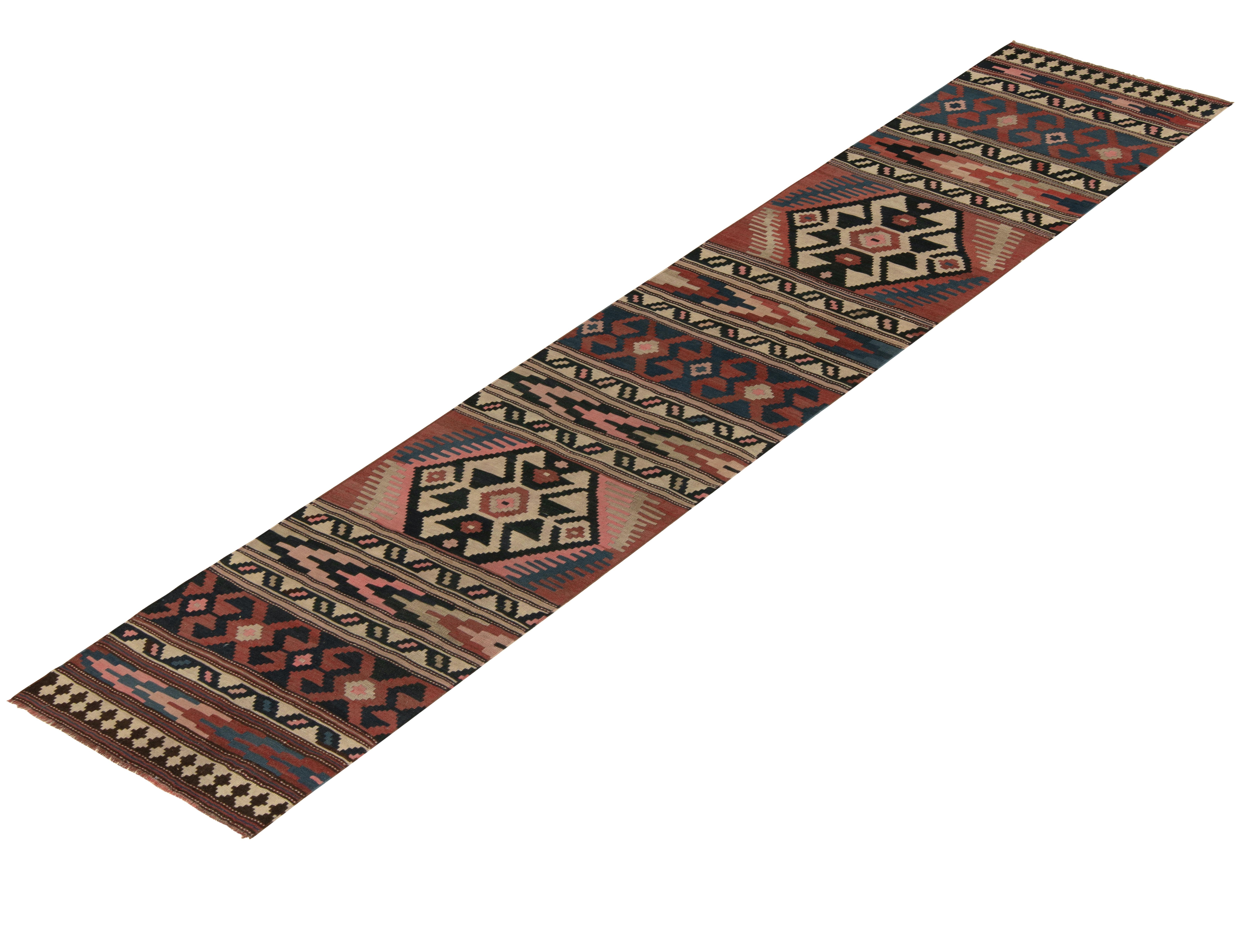 Hailing from Turkey circa 1950-1960, a rare mid-century kilim runner, now joining Rug & Kilim’s coveted vintage selections. 

The unusual tribal design revels in rare pink accents to the beige-brown, red and blue colorway lending a playful mood to