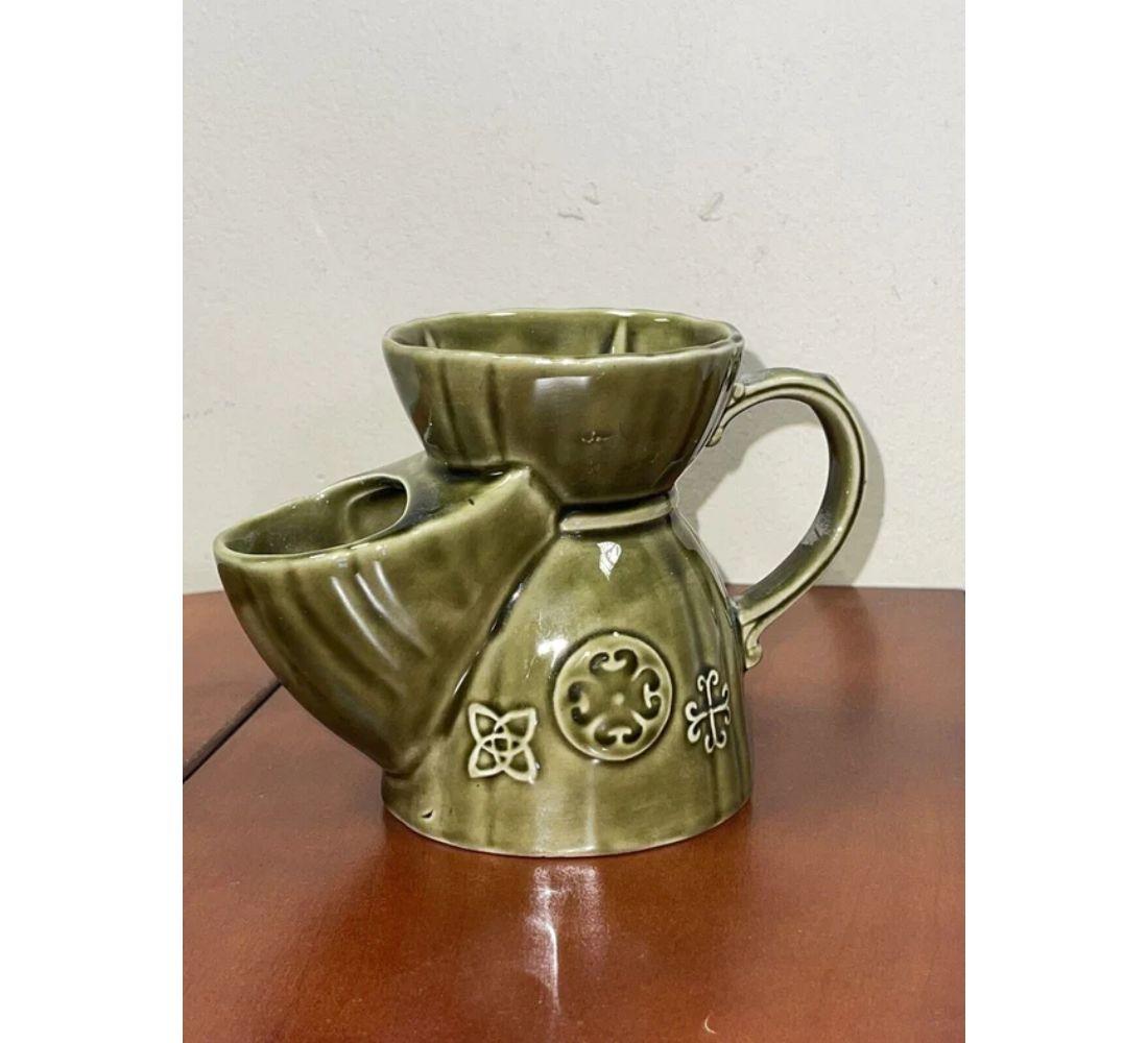 We are delighted to offer for sale this 1950s Vintage Lord Nelson Olive Green Pottery Shaving Scuttle Jug

This would make a great gift, stylish bathroom decor or could be used as a small vase or pen pot for the home office.
  