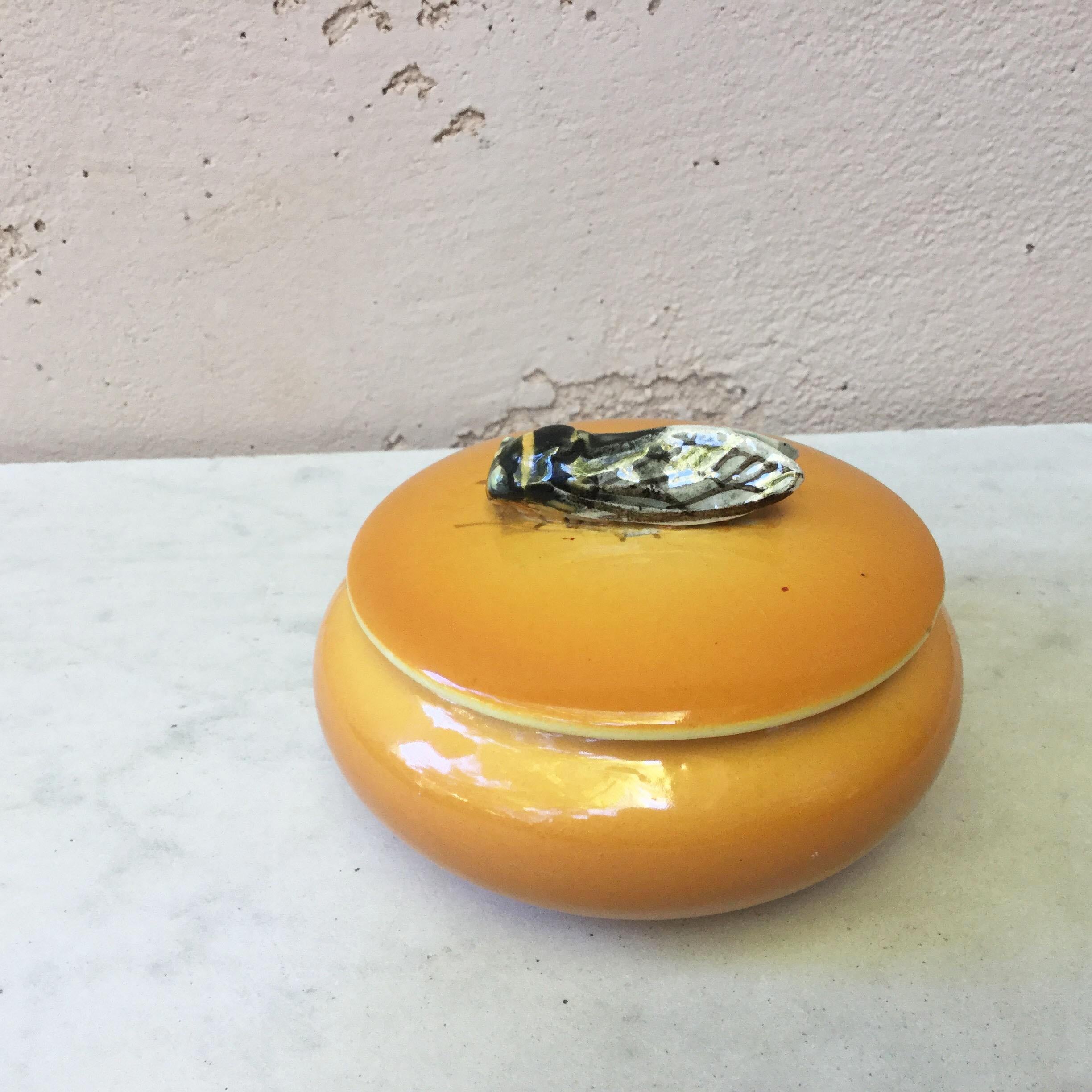 Yellow majolica box with a cicada on the handle. The piece is signed Sicard, circa 1950. Provencal style.