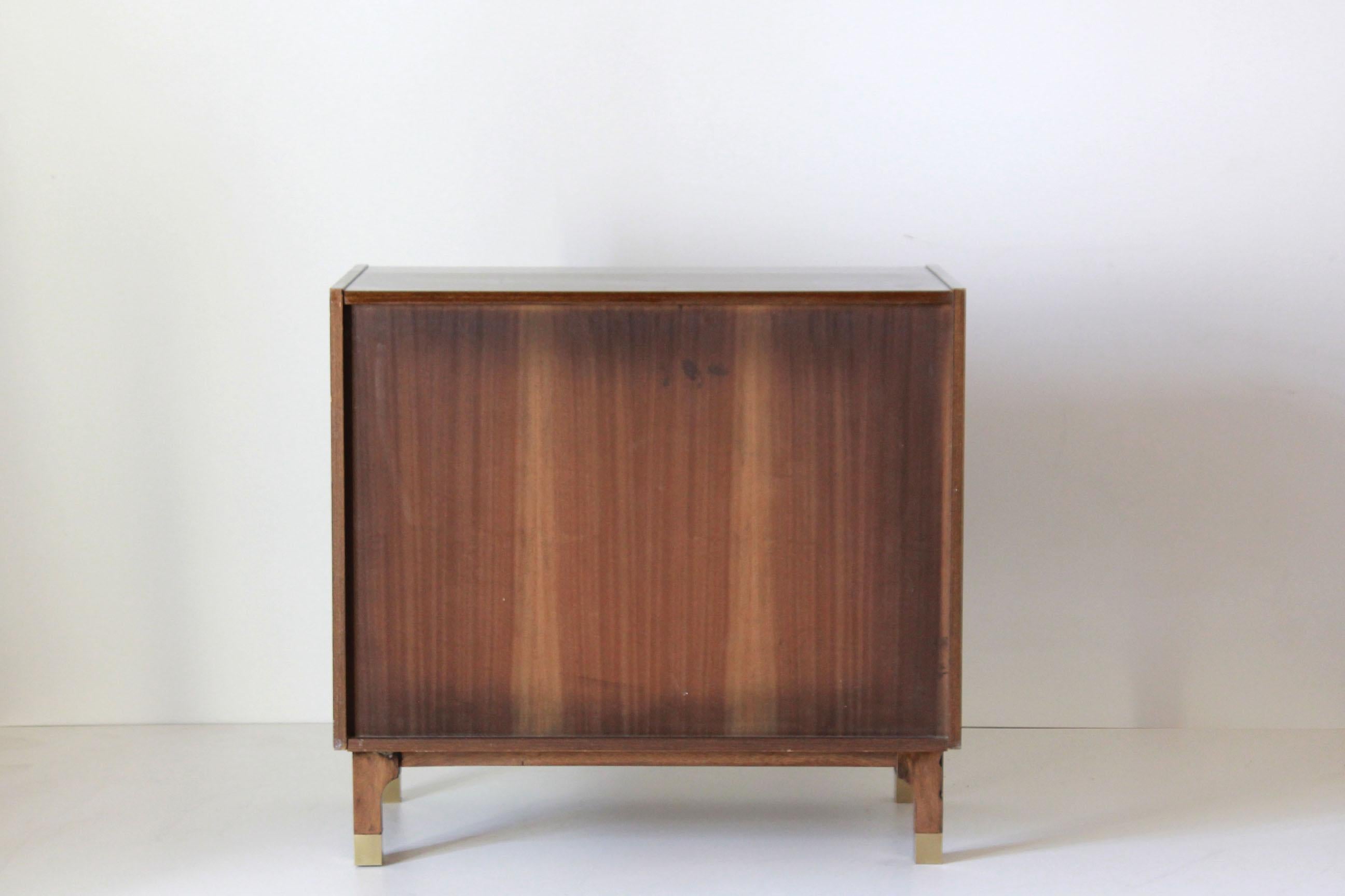 A 1950s small vintage sideboard. Veereed finishing with brass handles. In really good conditions with only some signs of time. All parts are the original ones. Typical midcentury modern Italian style.