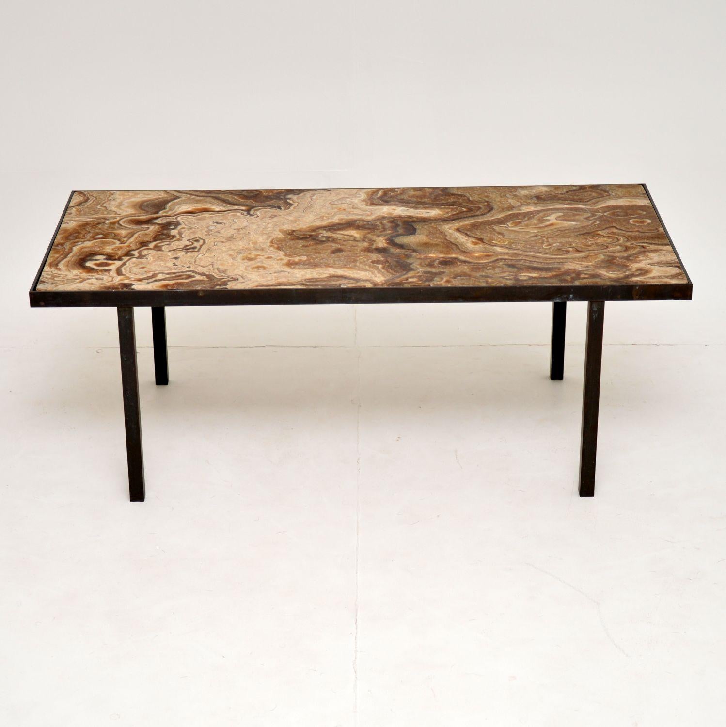 A beautiful vintage coffee table dating from the 1950s-1960s. This has an absolutely stunning inset marble top, we’ve never seen marble patterns that look this beautiful before! The frame is solid brass that has acquired a beautiful heavy patina
