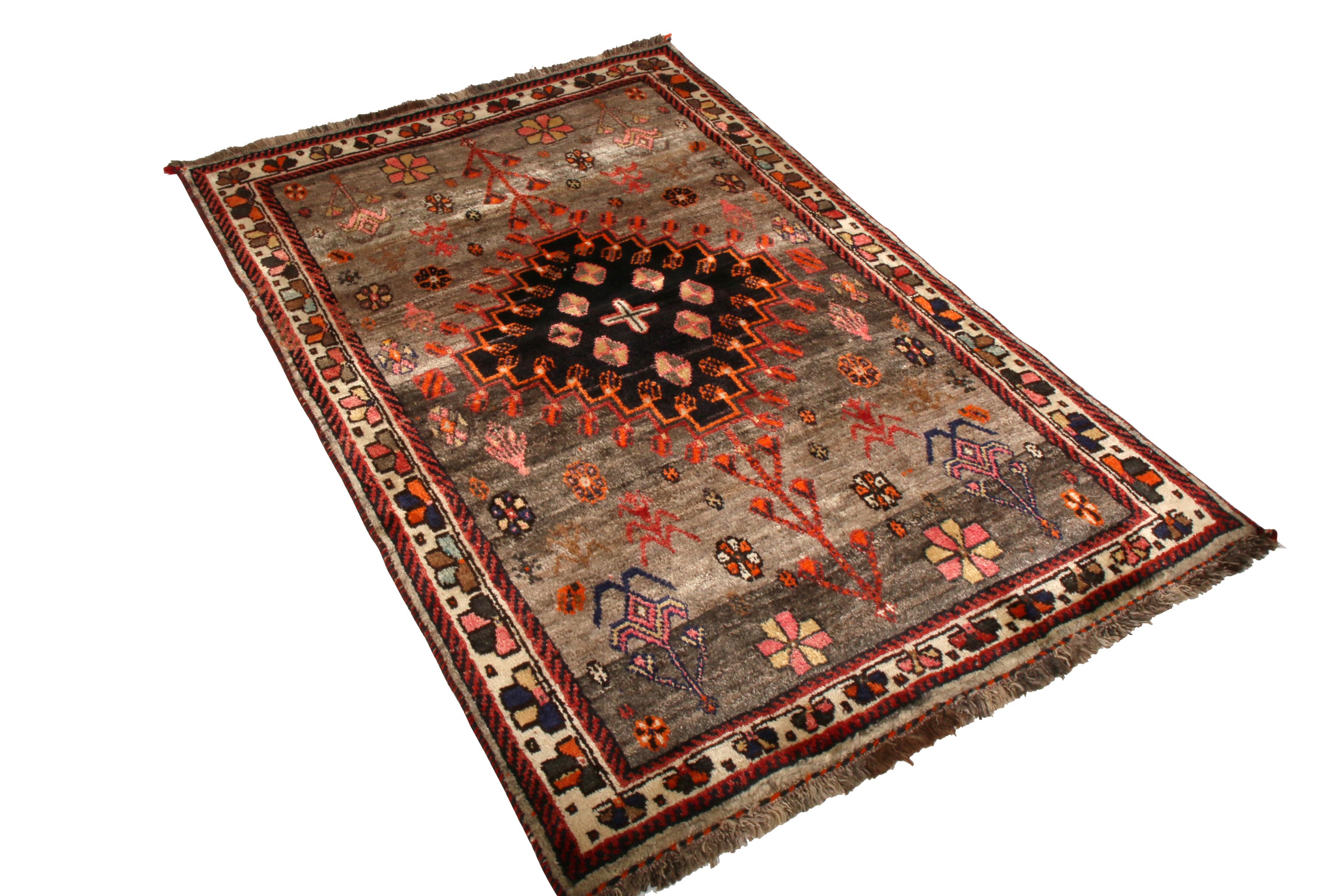 Hand knotted in wool originating between 1950-1960, this vintage midcentury Persian rug enjoys one of the most distinct colorways among this Classic lineage, identified as a vintage Gabbeh rug departing from the more common geometric preferences of