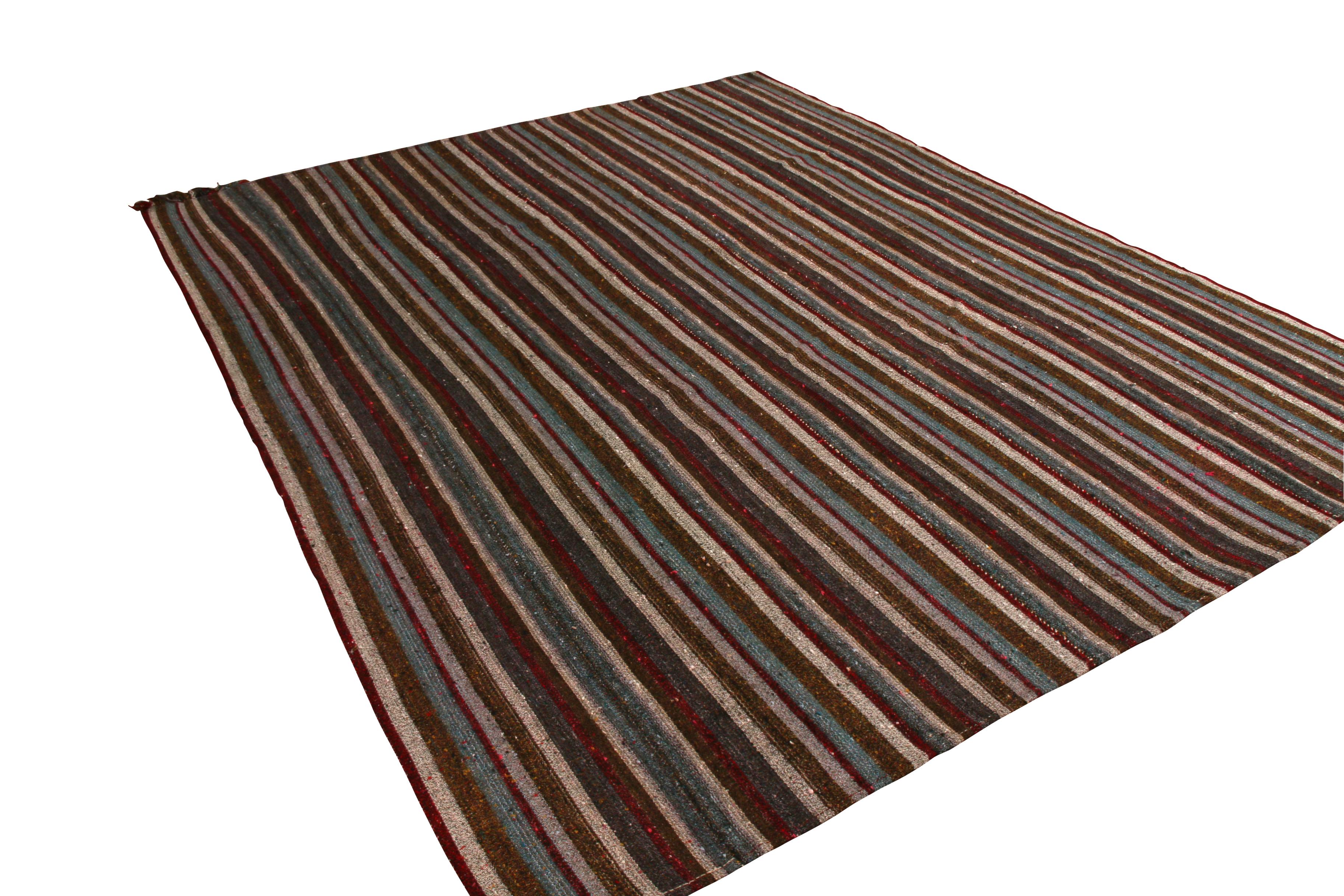 Handwoven in wool originating from Turkey between 1950-1960, this vintage mid-century Kilim enjoys one of the most subtle employments of a richer colorway among our recent acquisitions of this venerated style of paneled flat-weave rugs. The richness