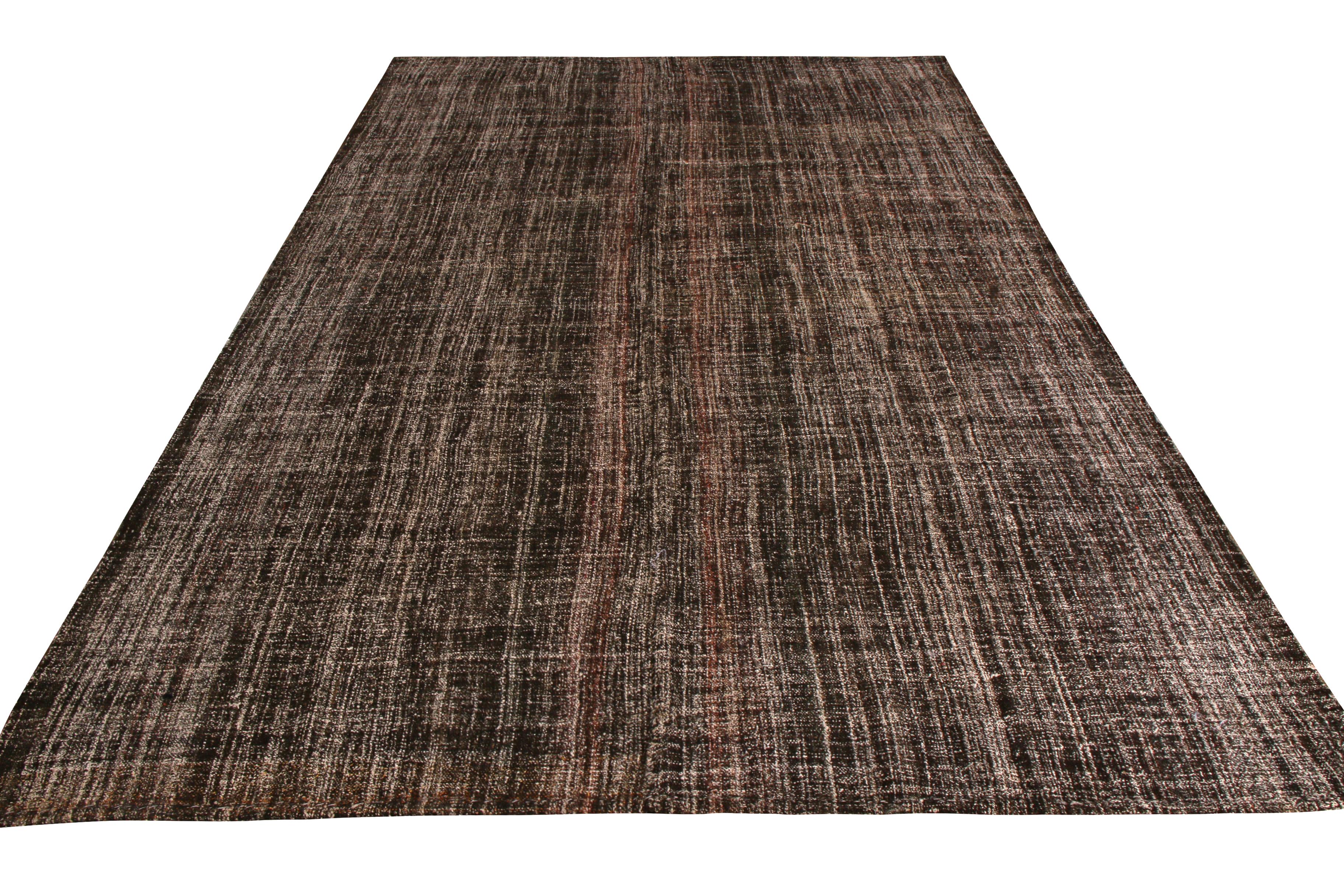 Handwoven in wool originating from Turkey between 1950-1960, this vintage midcentury striped Kilim rug enjoys a rare distinction through subtlety, employing subtle rich colorway variations in the striped-meets-solid beige brown pattern lending a